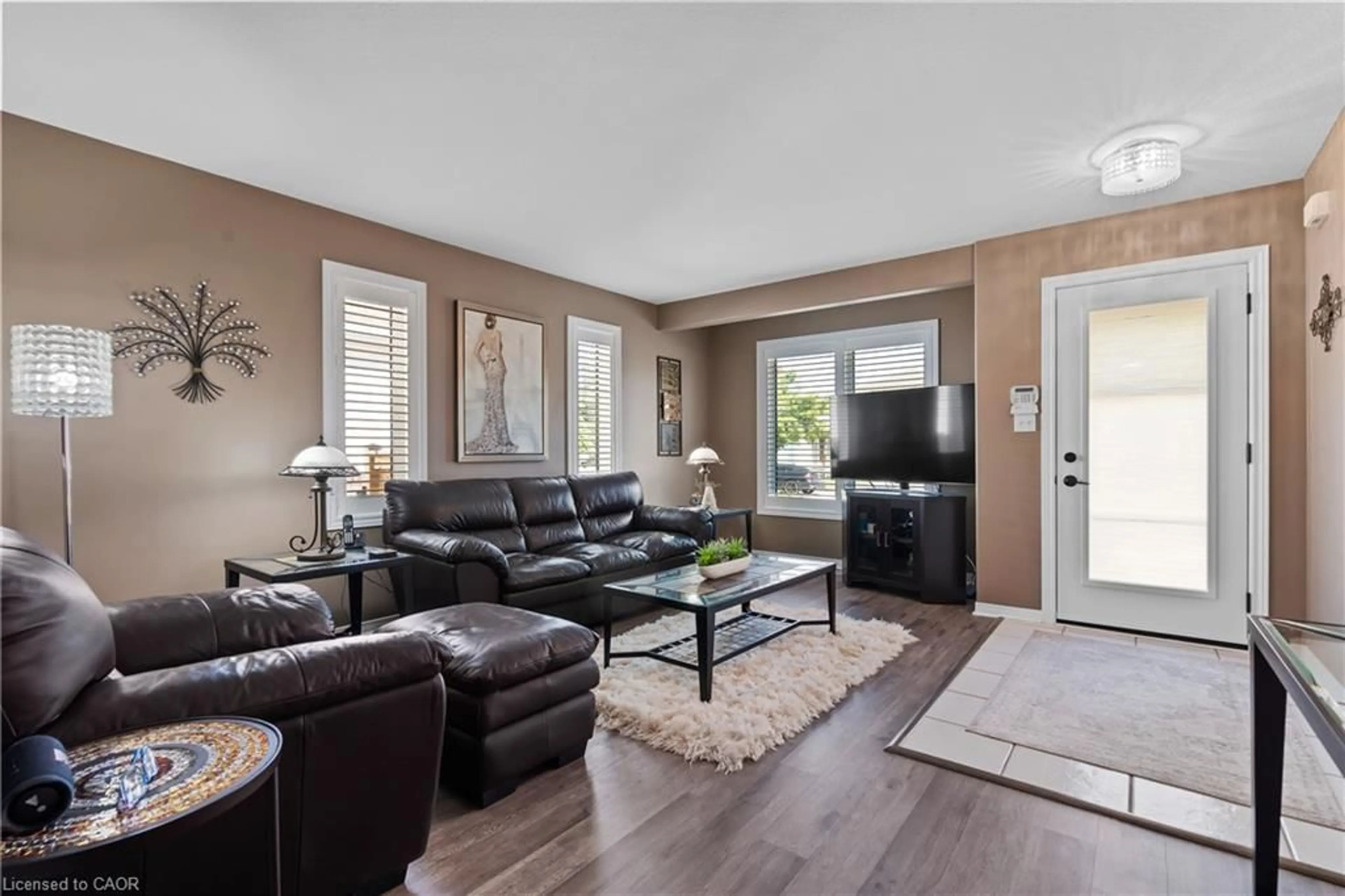Living room with furniture, wood/laminate floor for 208 Autumn Cres, Welland Ontario L3C 7K2