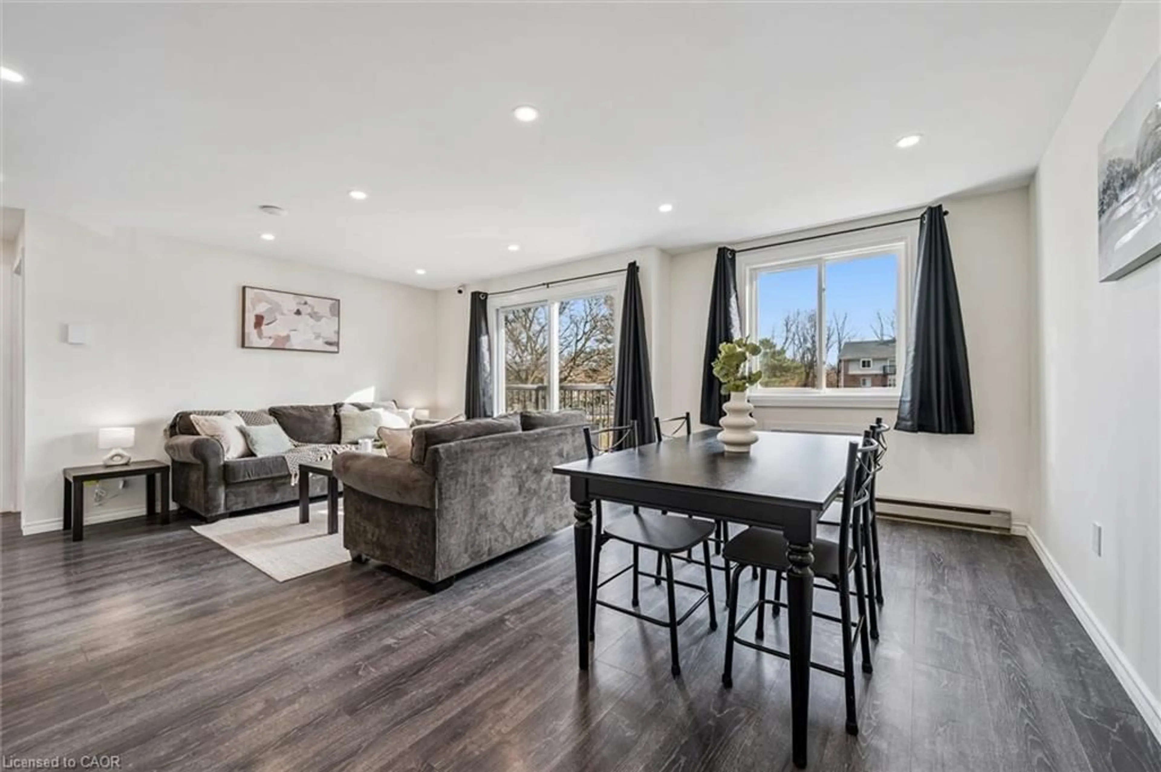 Living room with furniture, wood/laminate floor for 276 Eiwo Crt #208, Waterloo Ontario N2K 3M6