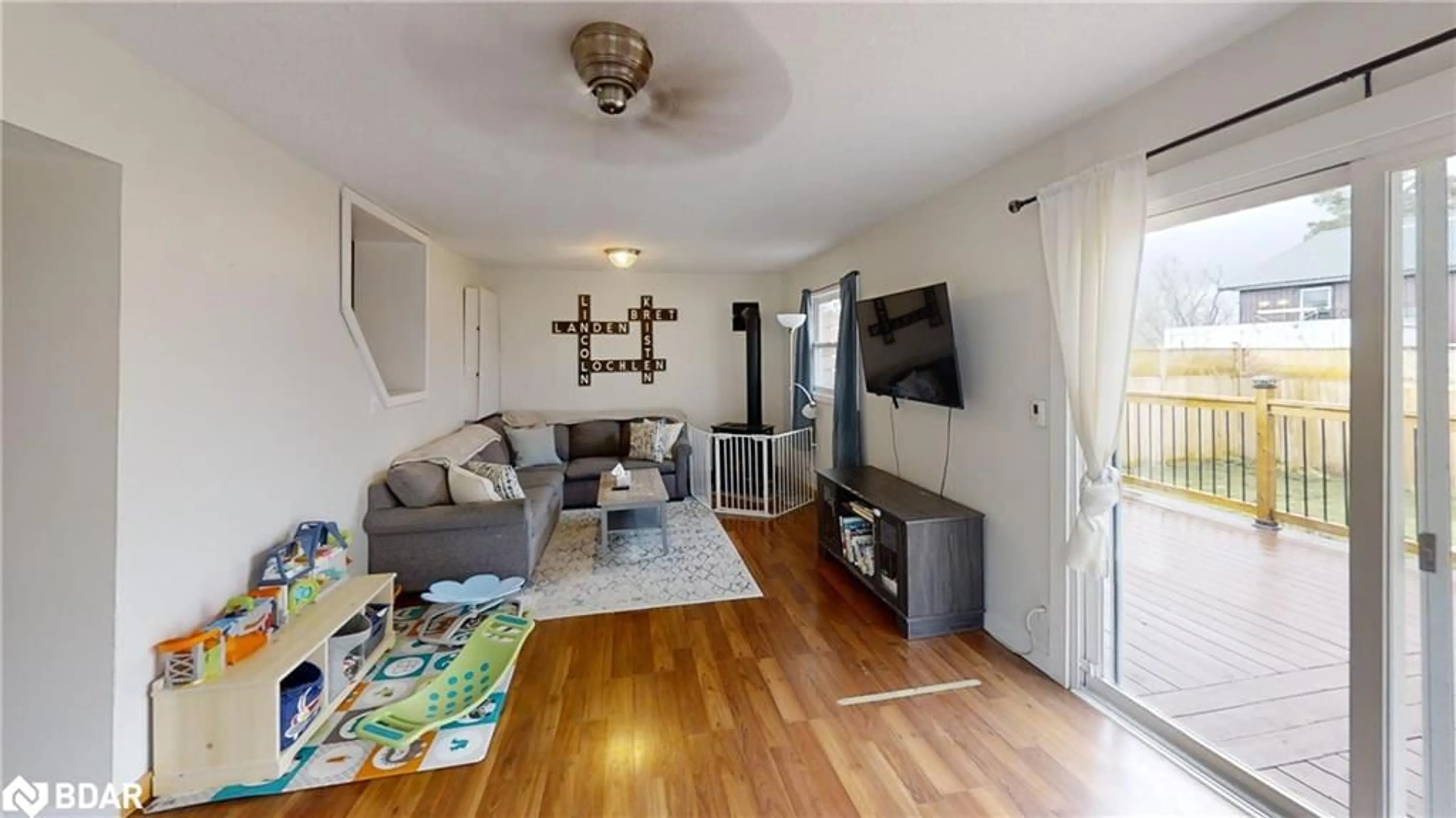 Living room with furniture, wood/laminate floor for 2214 Concession 10 Rd, Brechin Ontario L0K 1B0