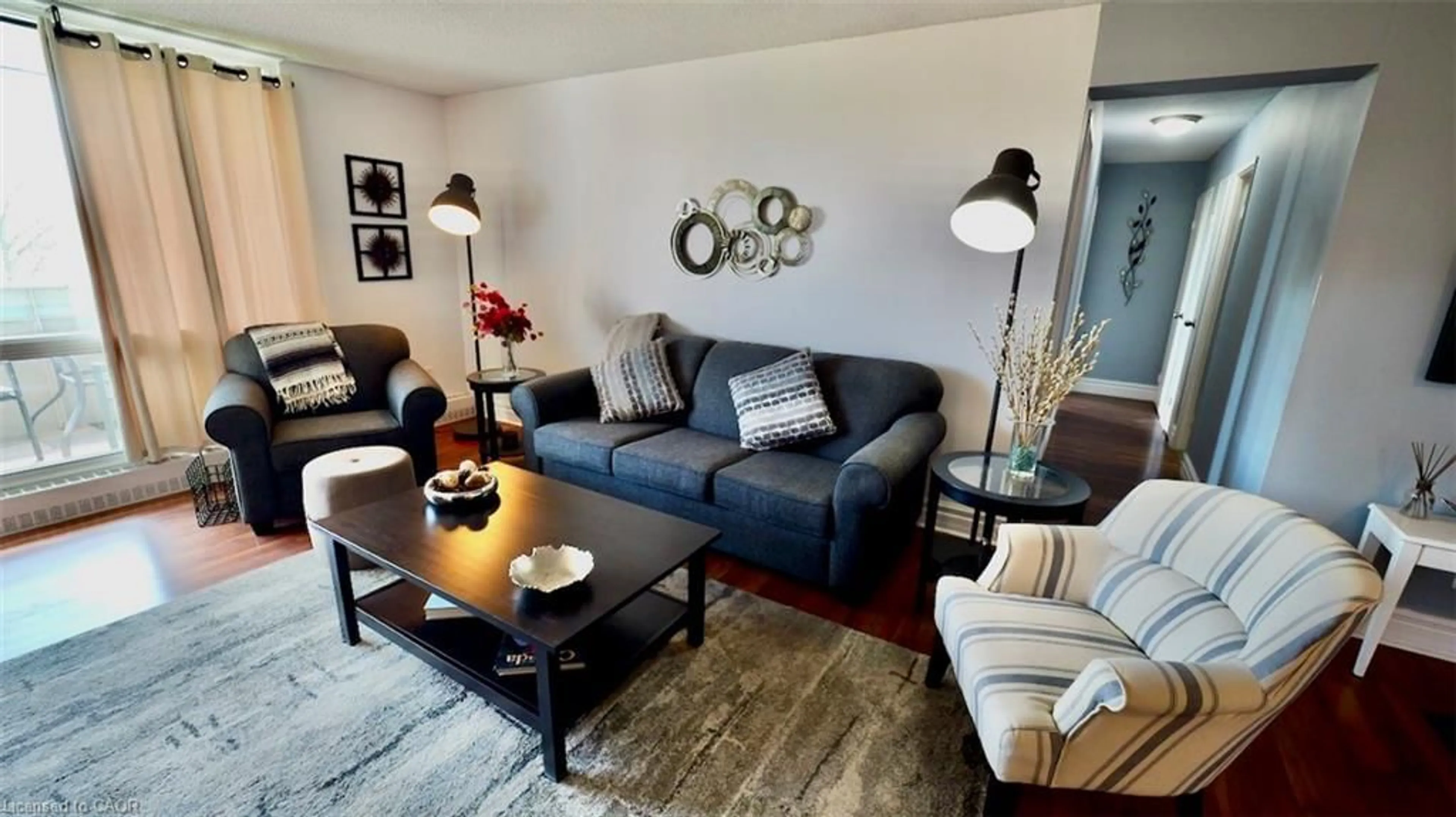 Living room with furniture, wood/laminate floor for 225 Harvard Pl #603, Waterloo Ontario N2J 4H4