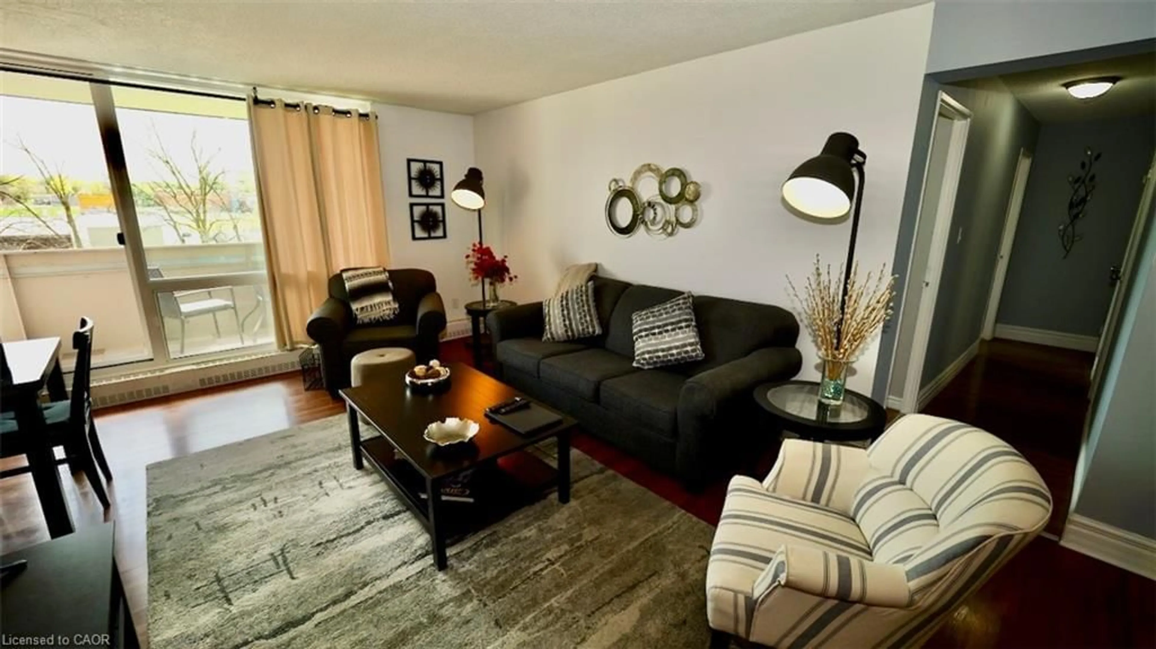 Living room with furniture, wood/laminate floor for 225 Harvard Pl #603, Waterloo Ontario N2J 4H4
