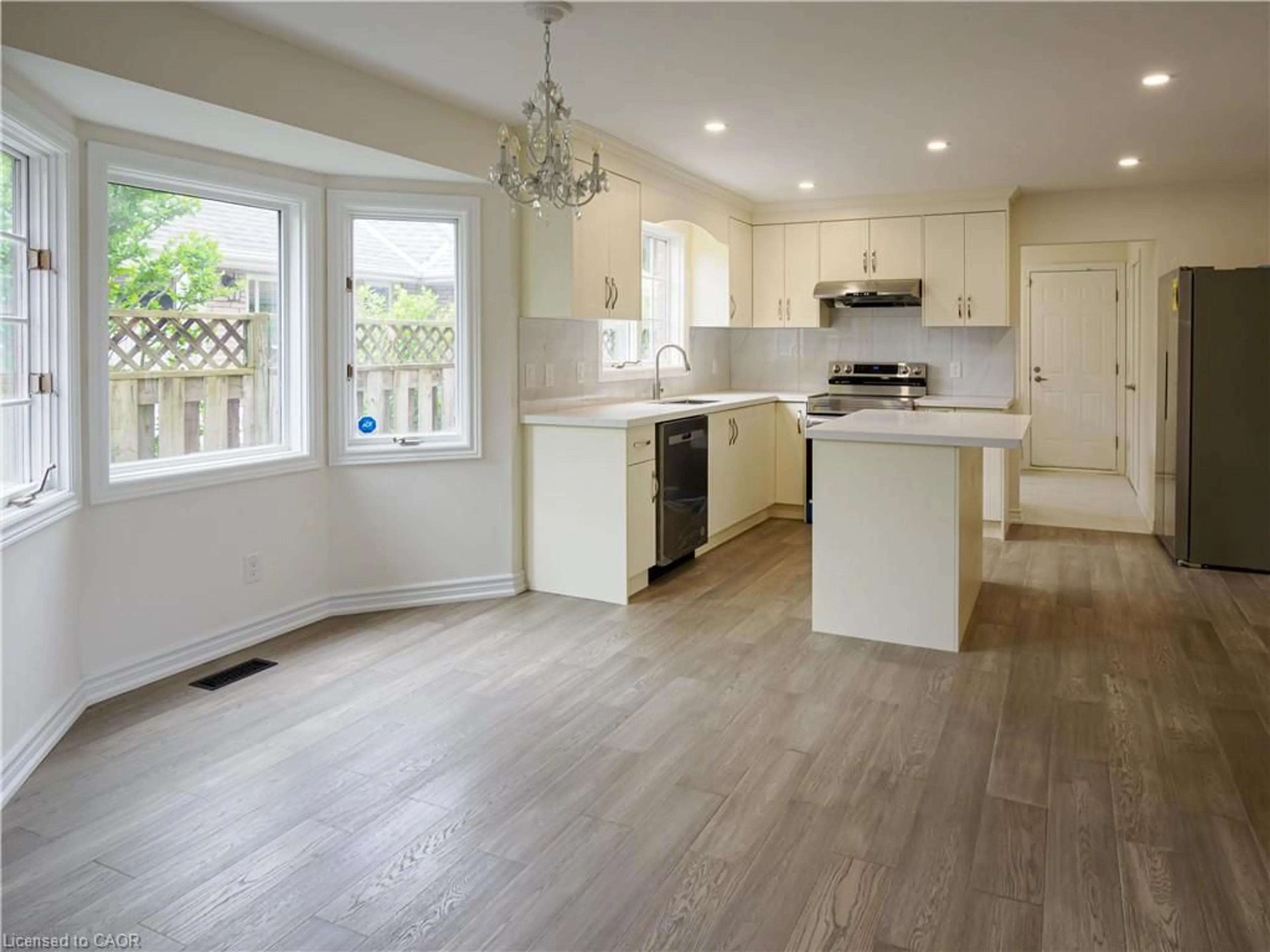Open concept kitchen, wood/laminate floor for 34 Mann Ave, Simcoe Ontario N3Y 5J3
