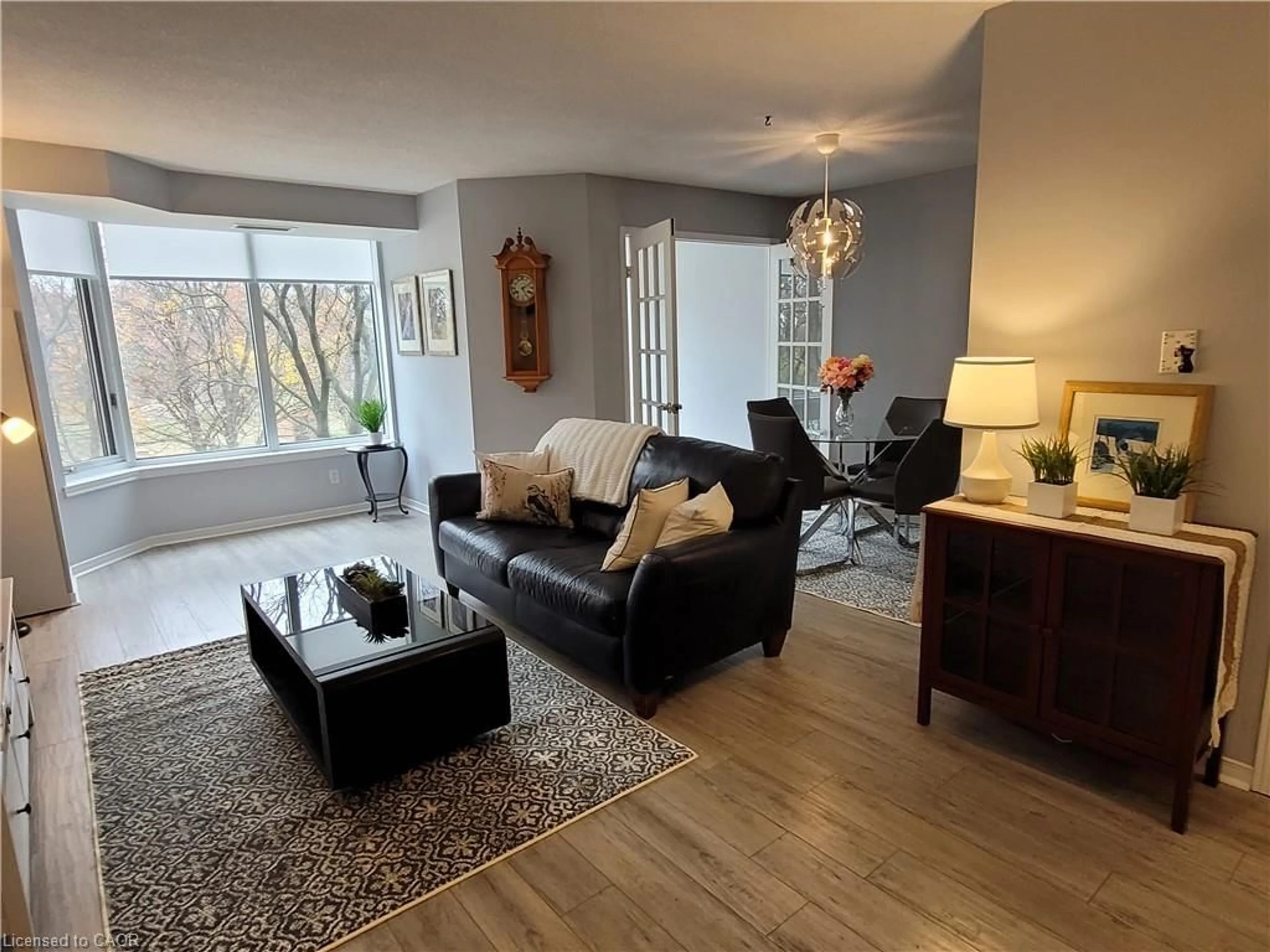 Living room with furniture, wood/laminate floor for 200 Limeridge Rd #308, Hamilton Ontario L9C 7M7