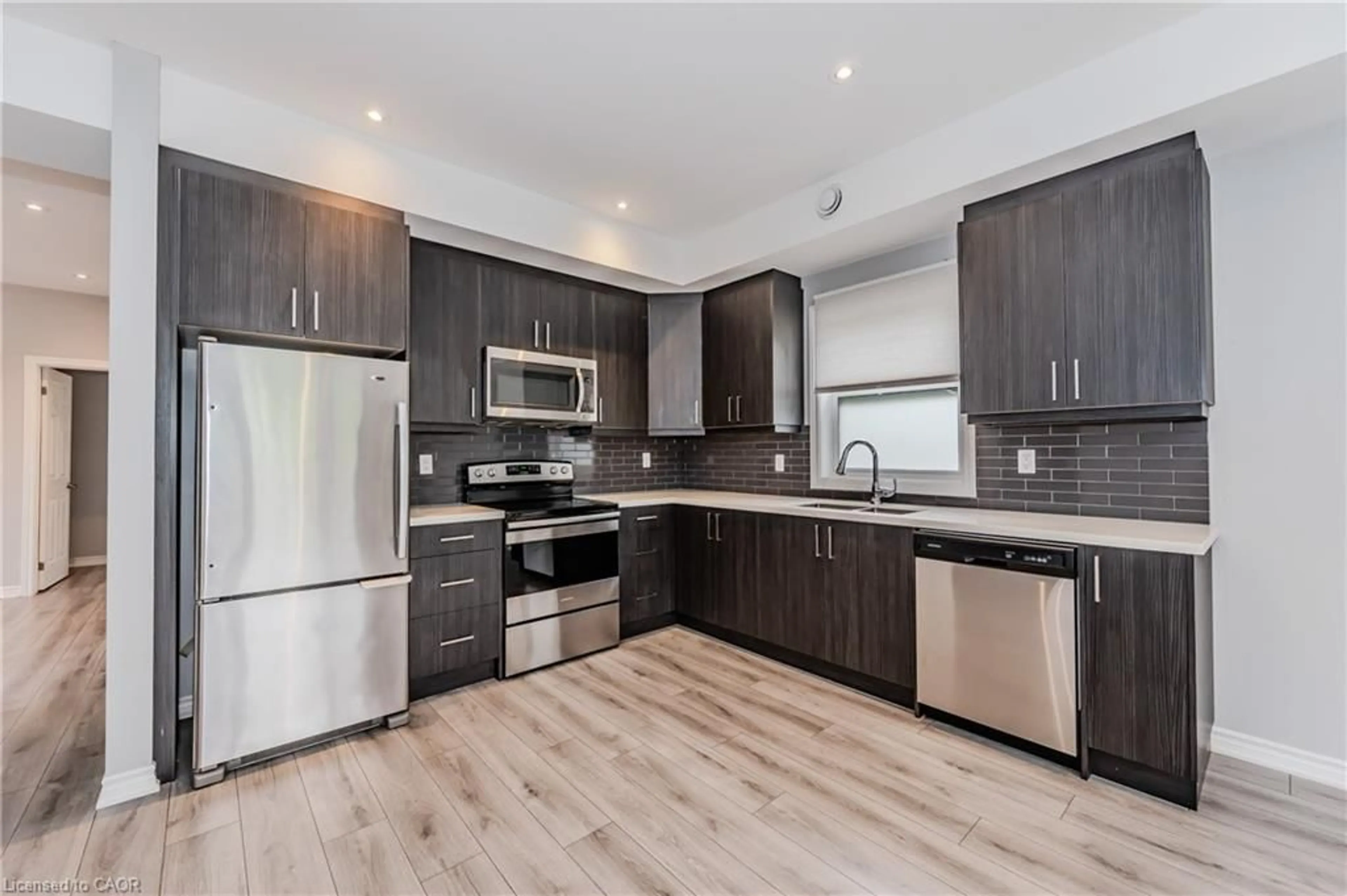 Open concept kitchen, wood/laminate floor for 17 Mary St #3, Kitchener Ontario N2H 3P9