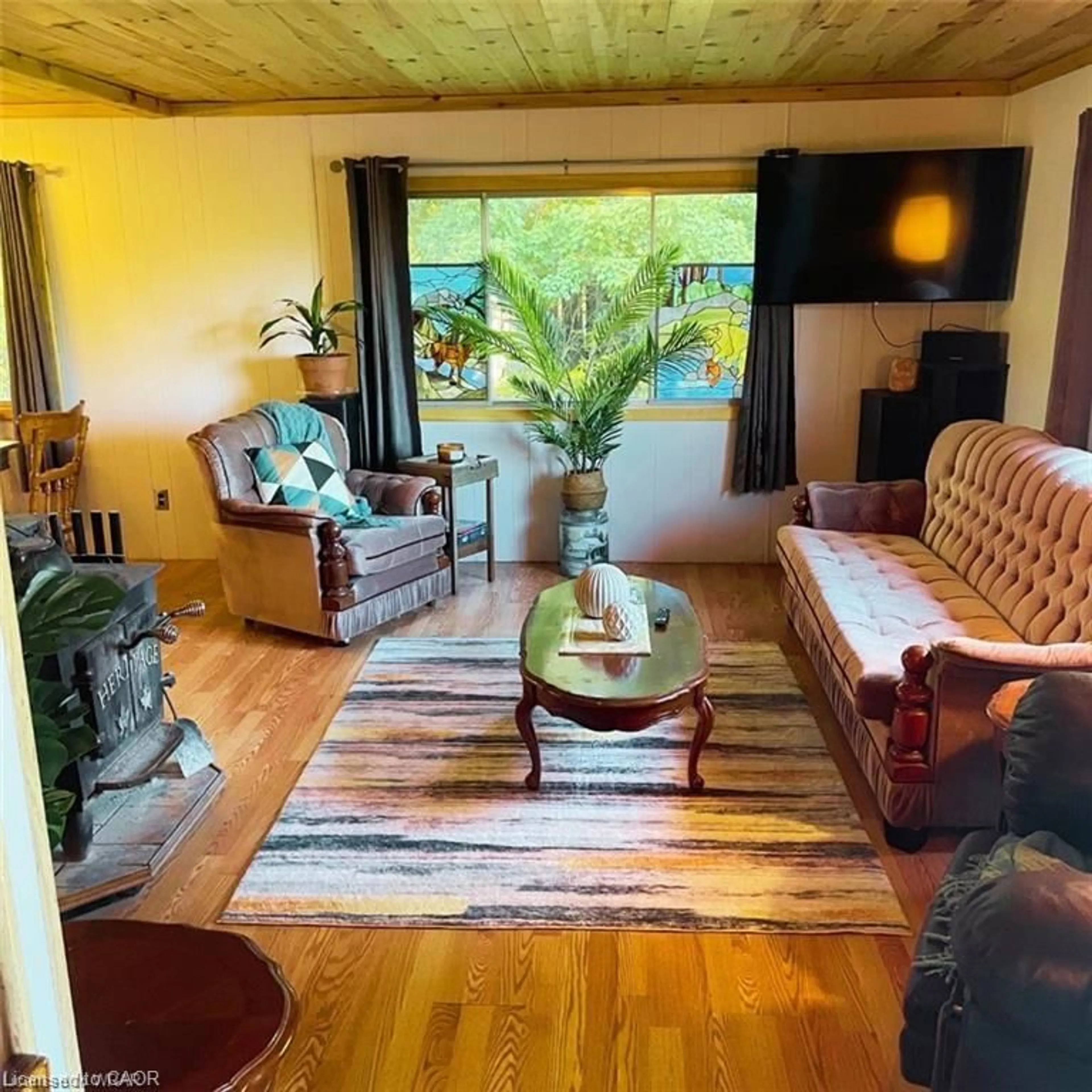 Living room with furniture, wood/laminate floor for 813016 East Back Line, Grey Highlands Ontario N0C 1L0