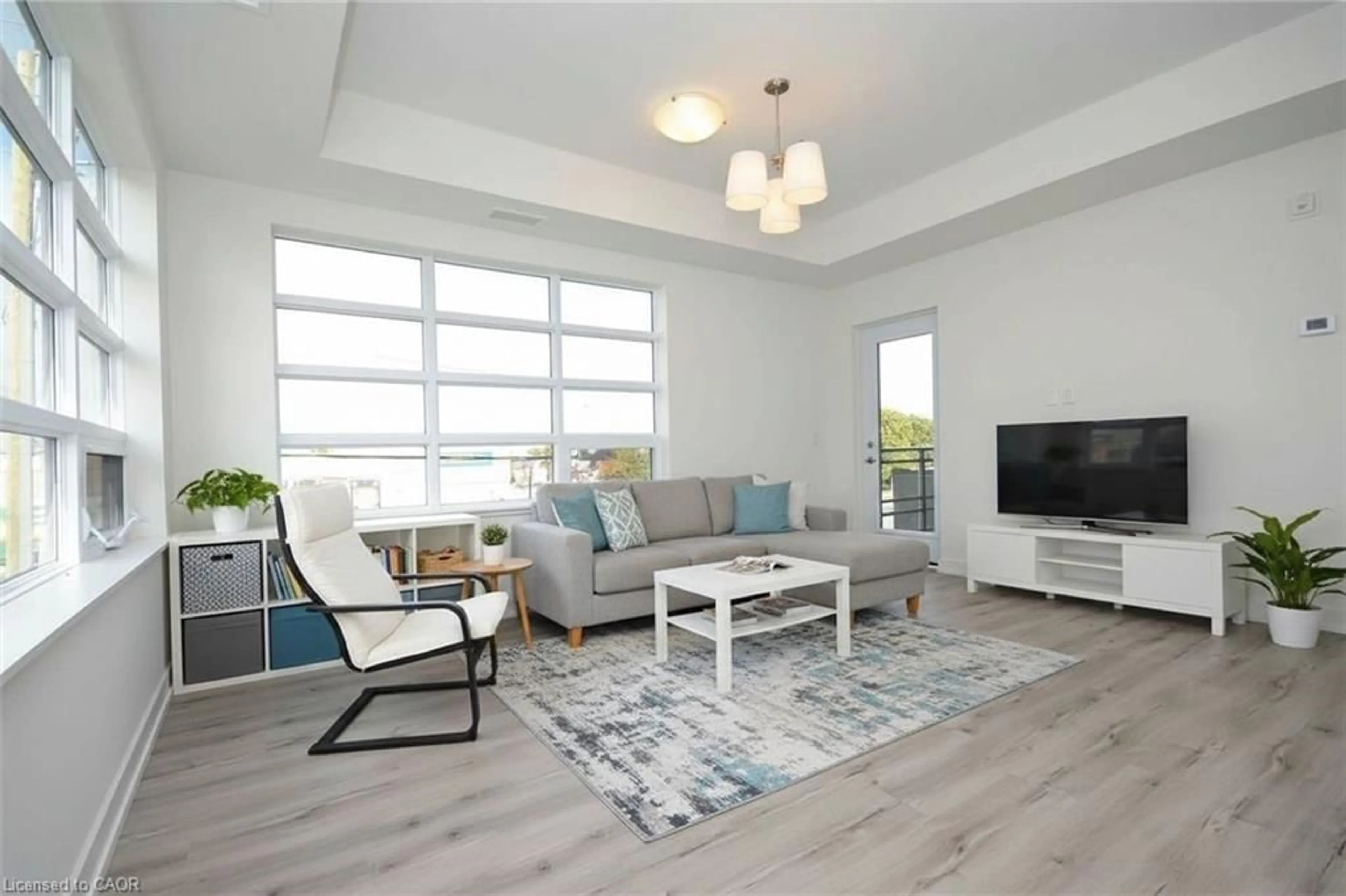 Living room with furniture, wood/laminate floor for 243 Northfield Dr #211, Waterloo Ontario N2K 0G9