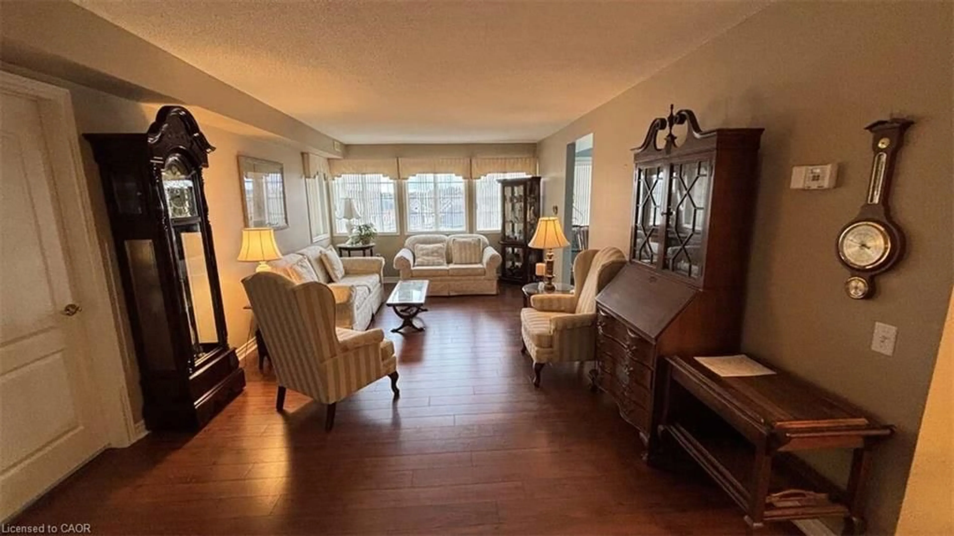 Living room with furniture, wood/laminate floor for 600 Silverbirch Blvd #308, Mount Hope Ontario L0R 1W0