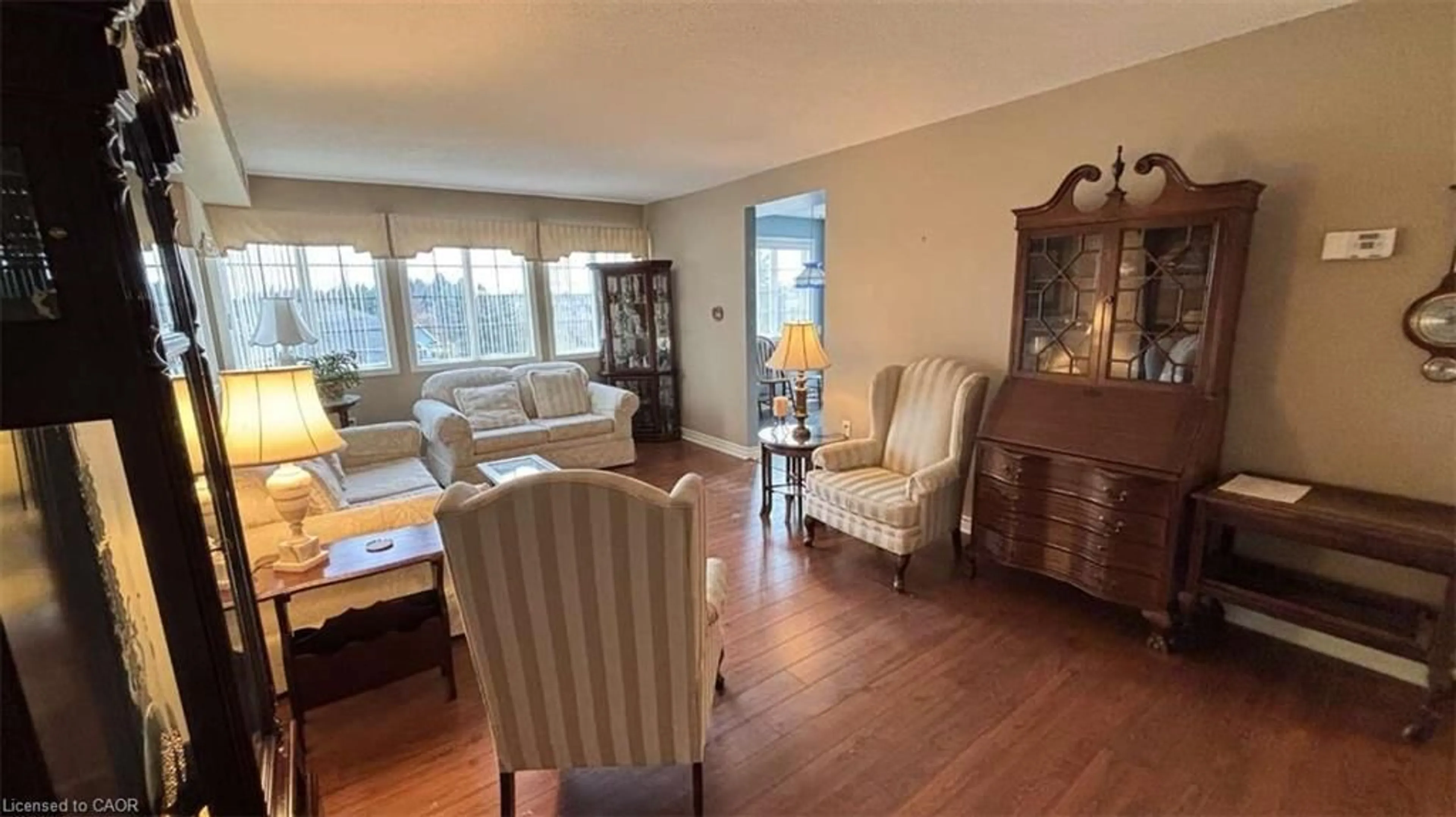 Living room with furniture, wood/laminate floor for 600 Silverbirch Blvd #308, Mount Hope Ontario L0R 1W0
