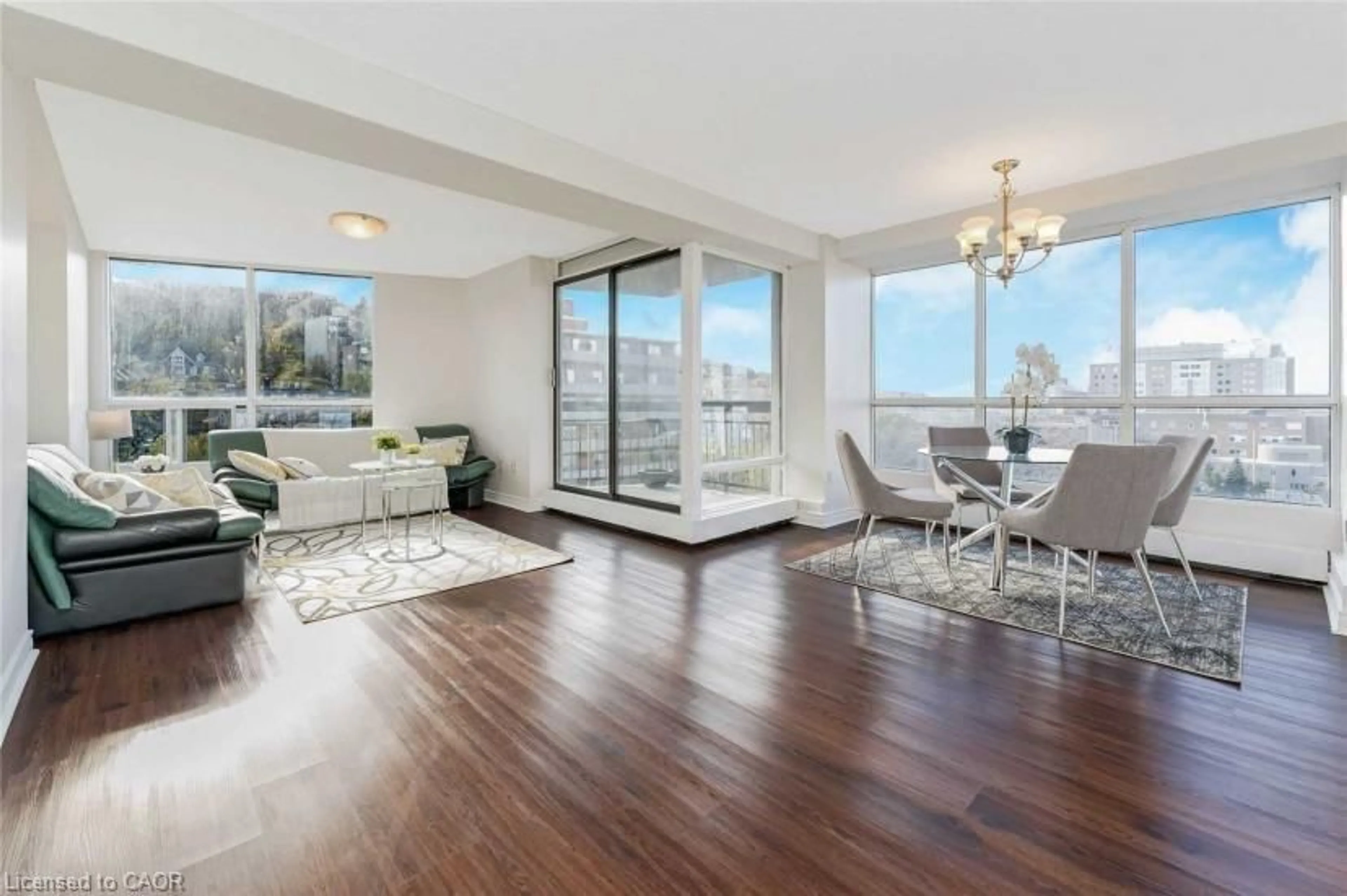 Living room with furniture, wood/laminate floor for 150 Charlton Ave #1208, Hamilton Ontario L8N 3X3