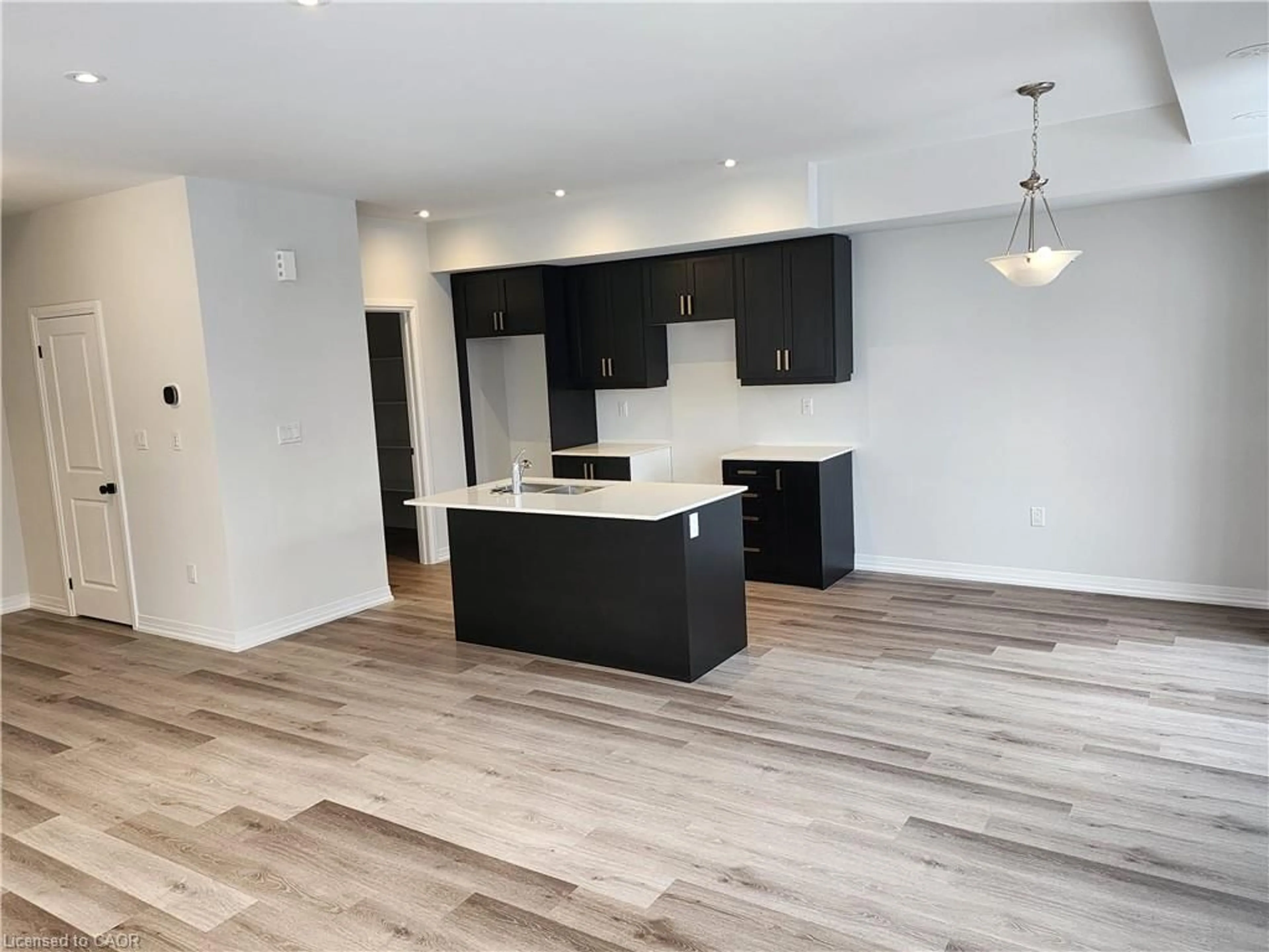 Open concept kitchen, wood/laminate floor for 155 Equestrian Way #121, Cambridge Ontario N3E 0E8
