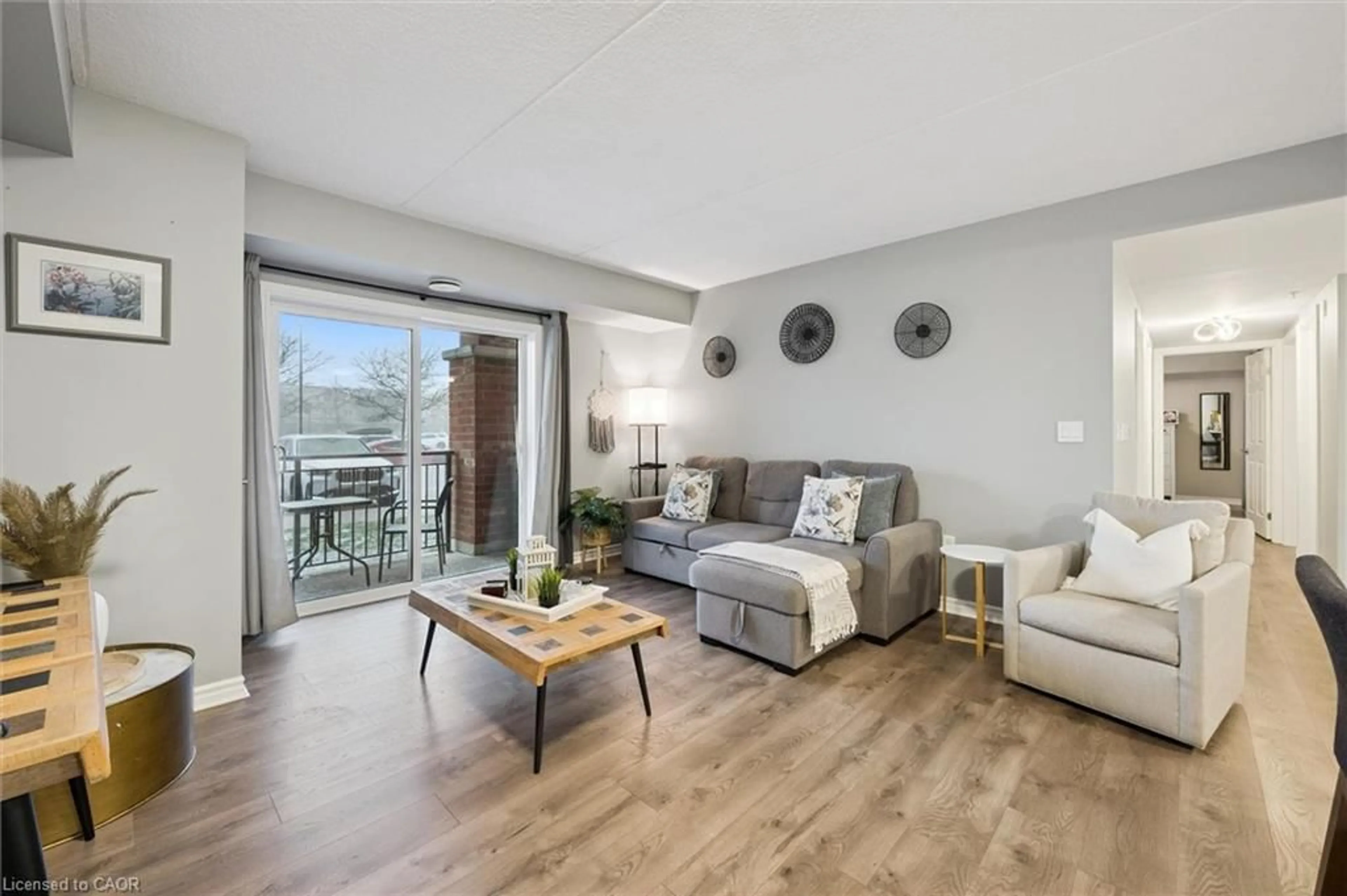 Living room with furniture, wood/laminate floor for 19 Waterford Dr #109, Guelph Ontario N1L 0G8