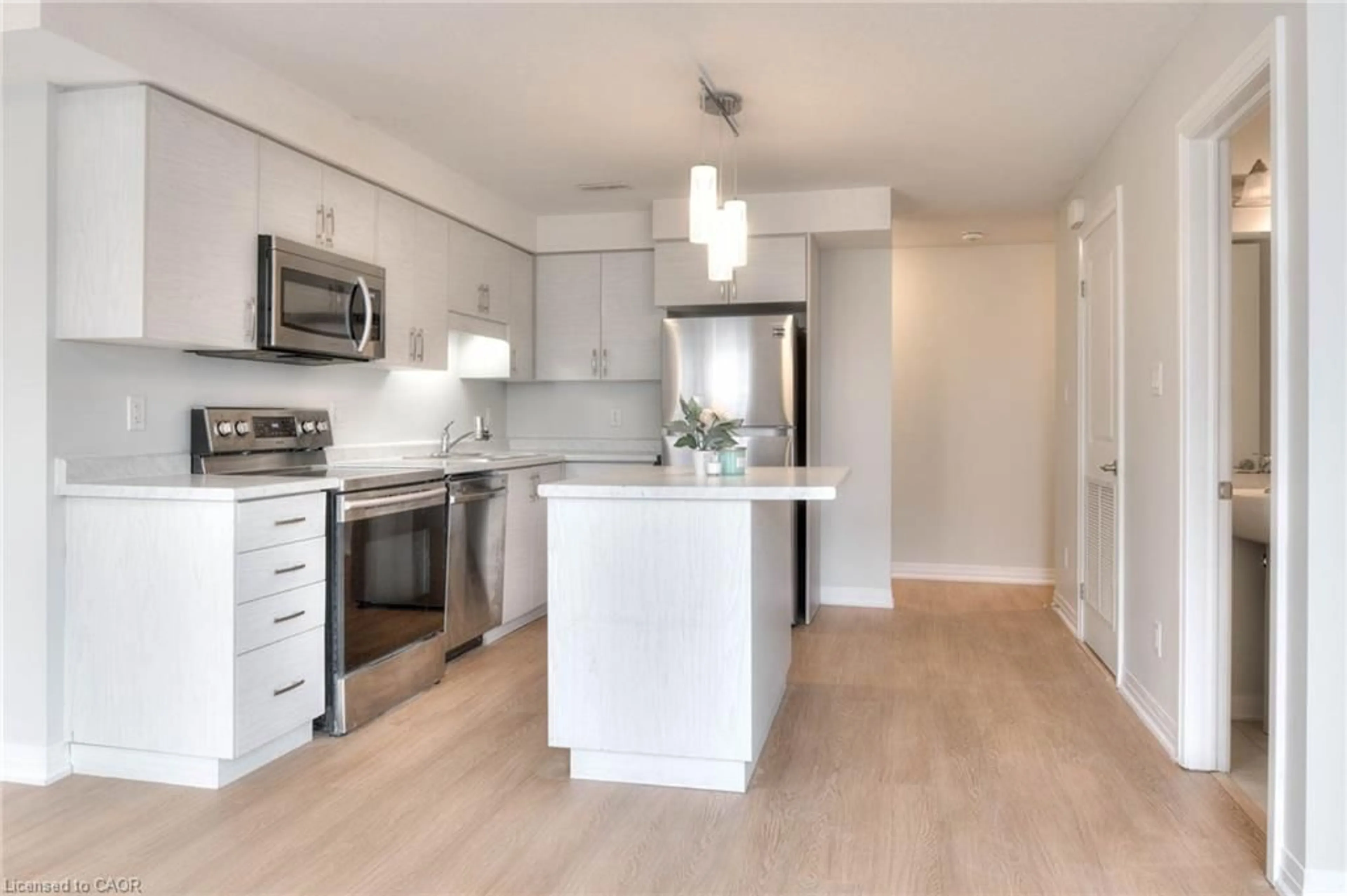Open concept kitchen, wood/laminate floor for 1989 Ottawa St #64D, Kitchener Ontario N2E 0G7