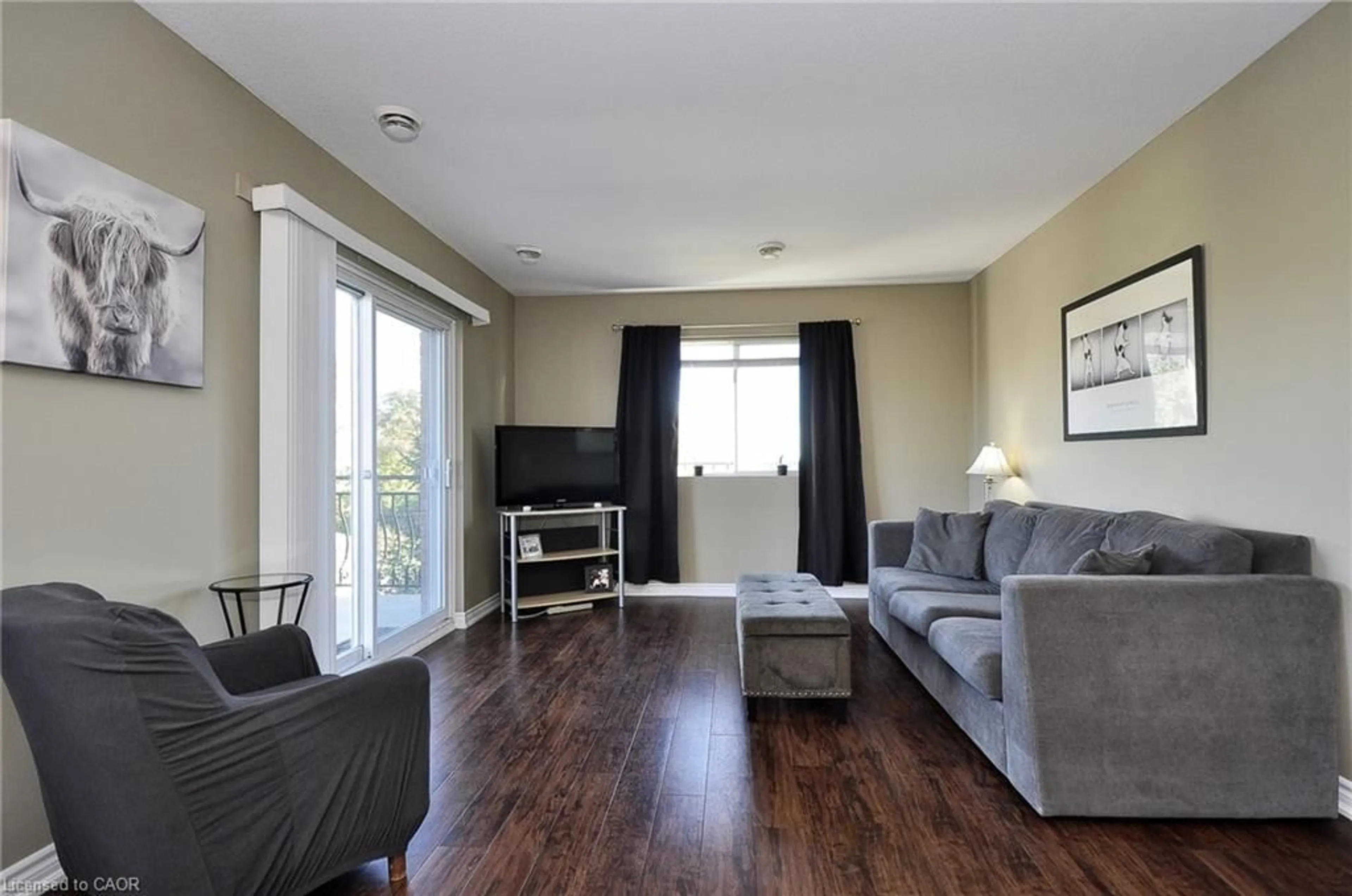 Living room with furniture, wood/laminate floor for 345 Briarmeadow Dr #302, Kitchener Ontario N2A 4J6