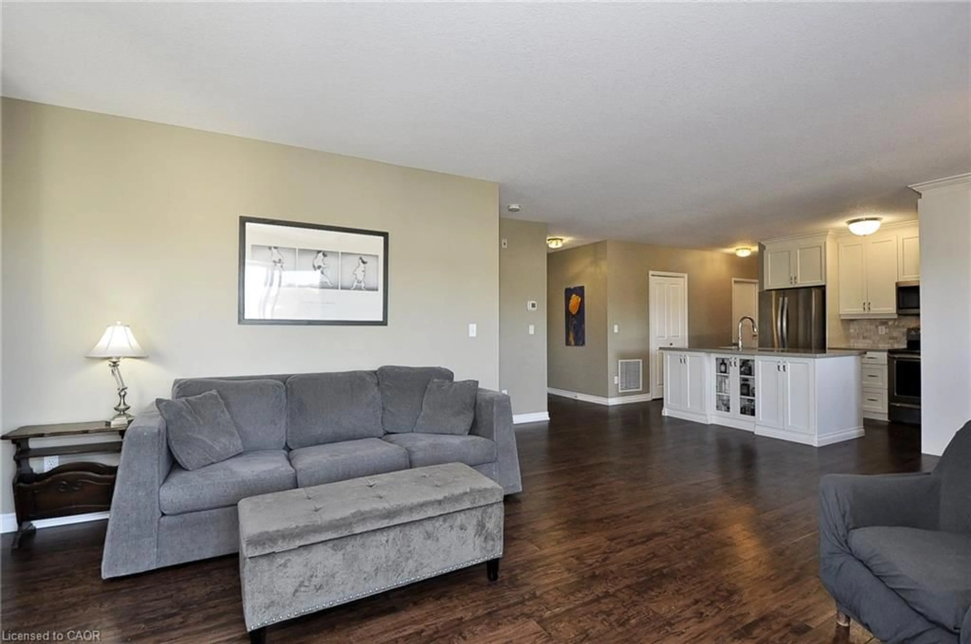 Living room with furniture, wood/laminate floor for 345 Briarmeadow Dr #302, Kitchener Ontario N2A 4J6