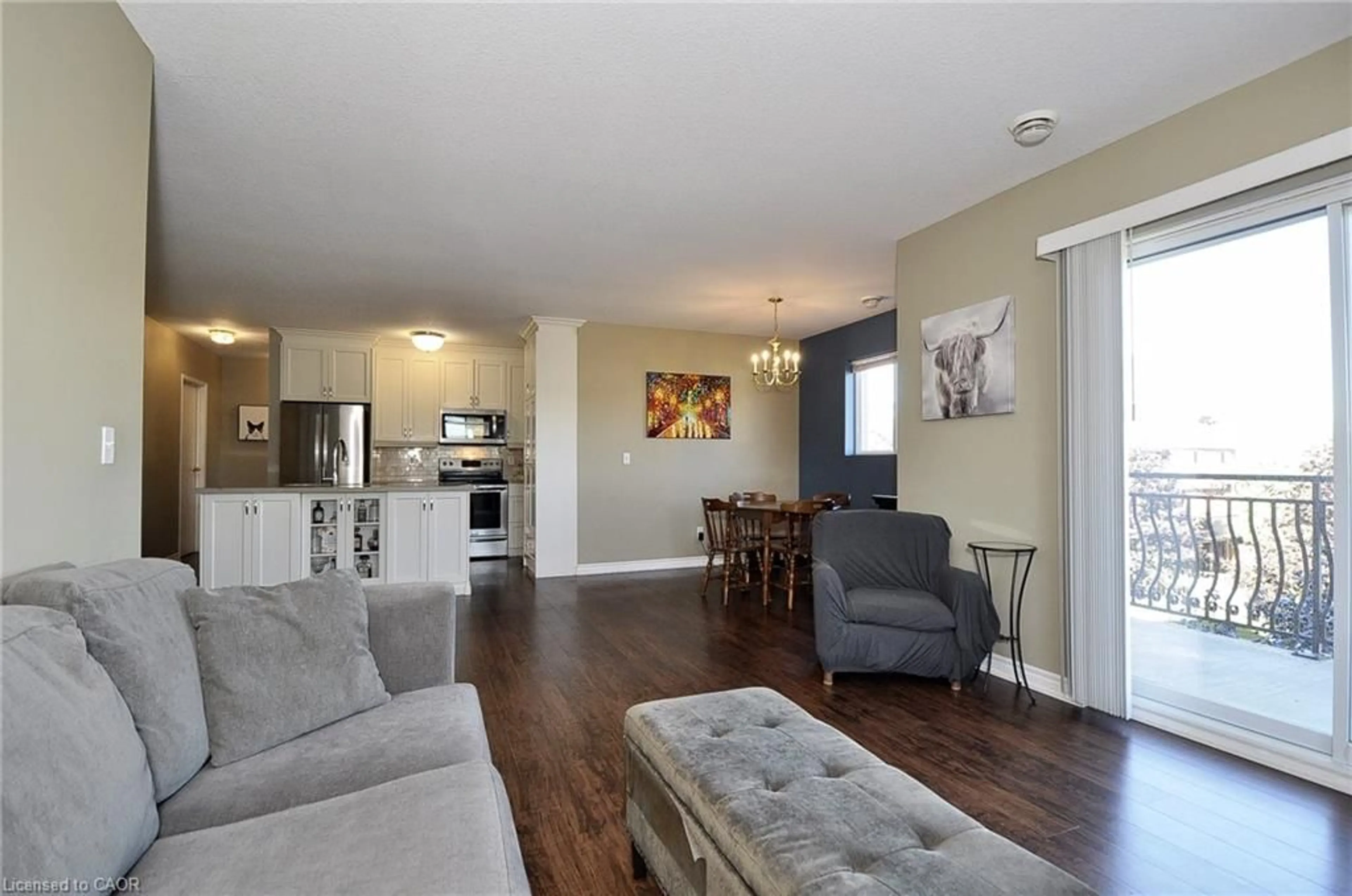 Living room with furniture, wood/laminate floor for 345 Briarmeadow Dr #302, Kitchener Ontario N2A 4J6