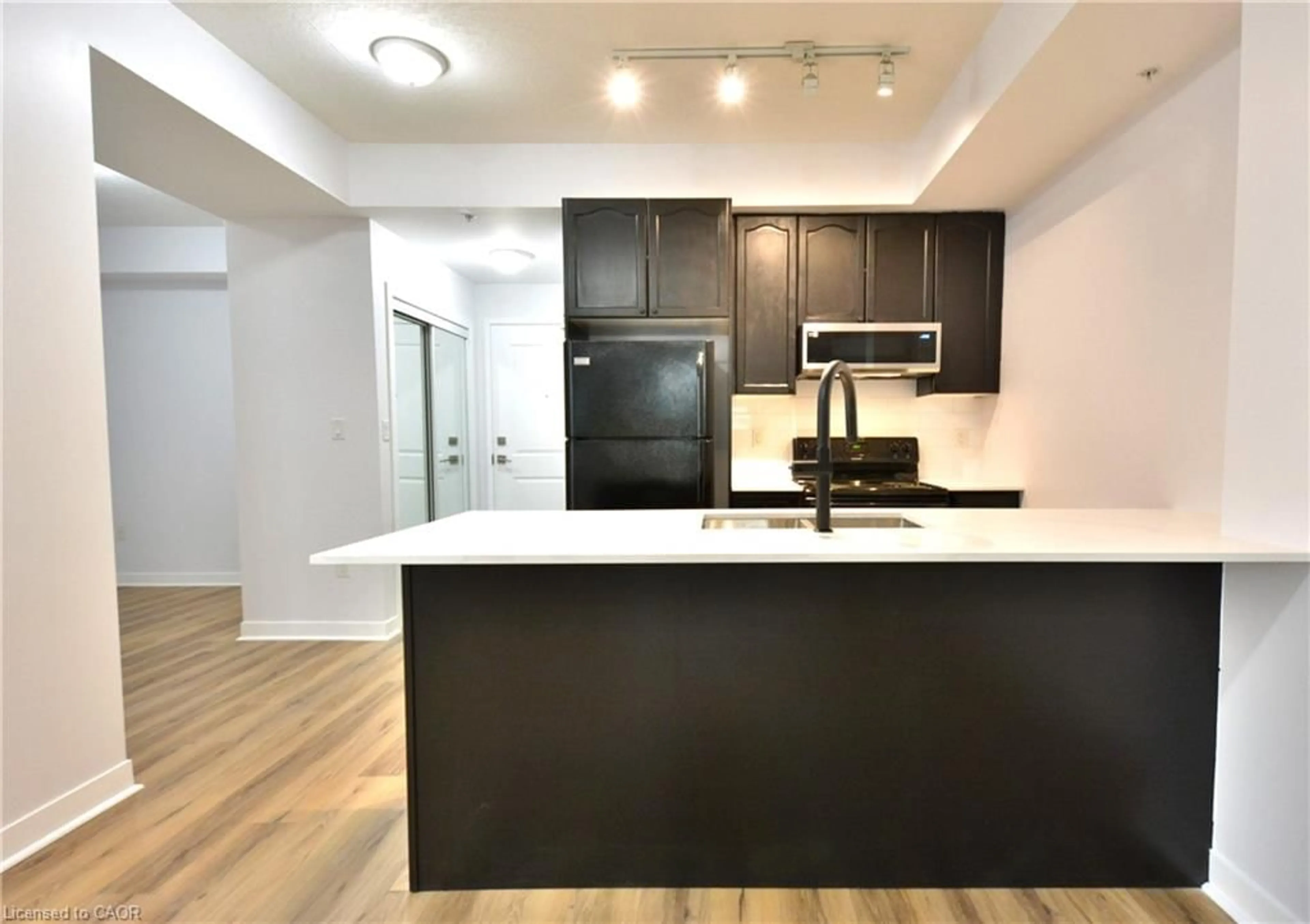Open concept kitchen, wood/laminate floor for 85 Robinson St #705, Hamilton Ontario L8P 0B9