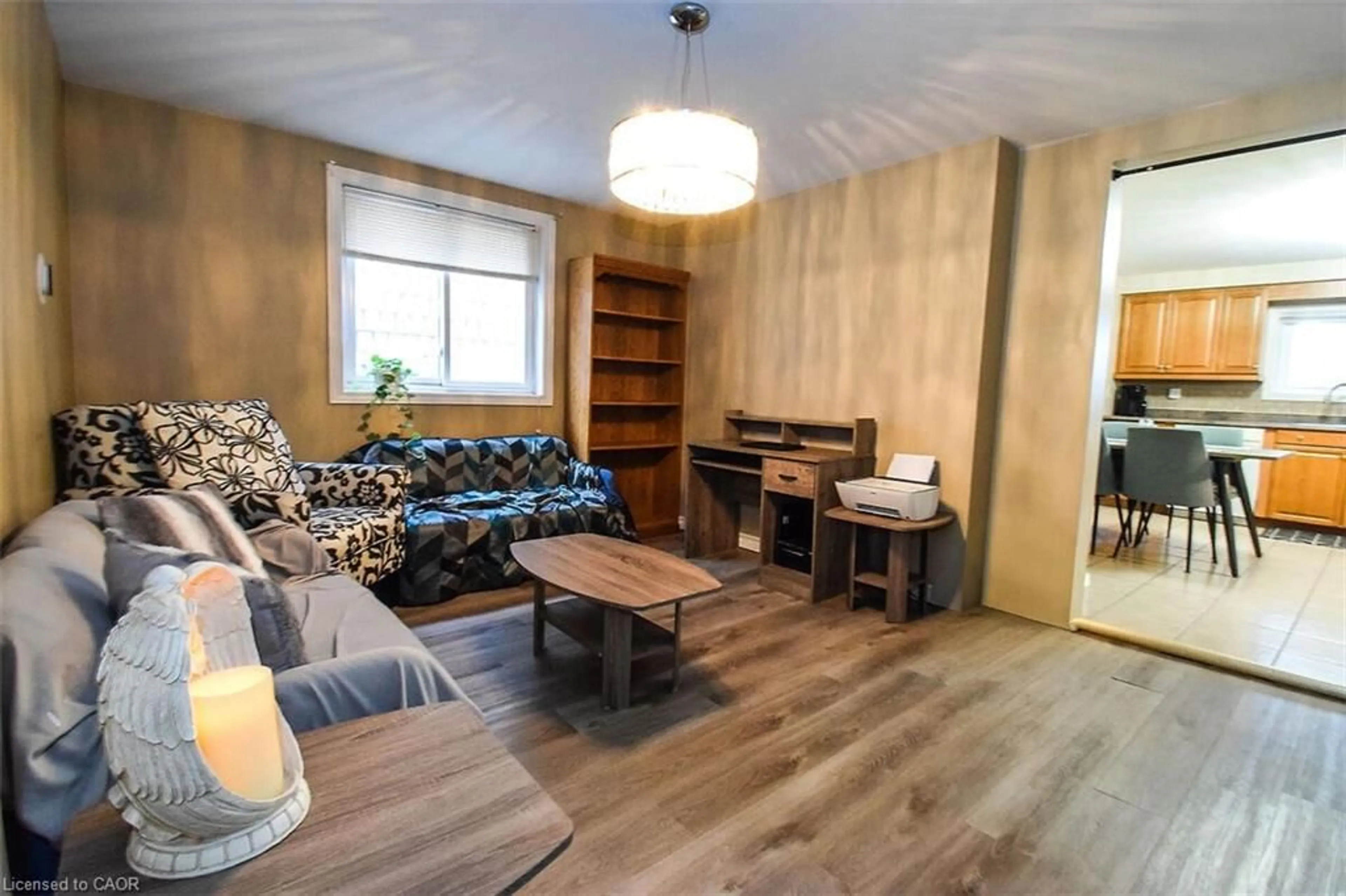 Living room with furniture, wood/laminate floor for 16 Land St, Hamilton Ontario L8L 4L1