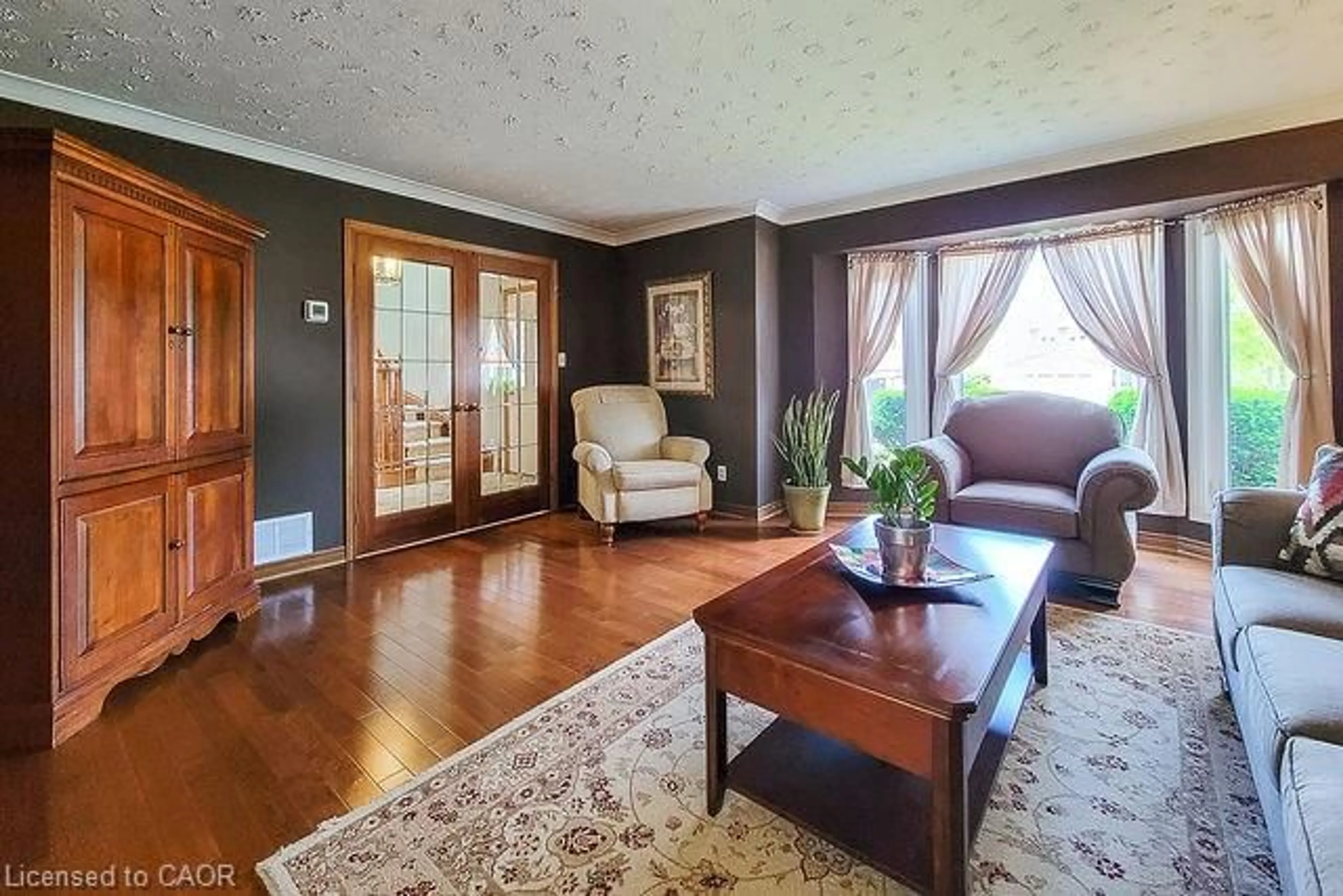 Living room with furniture, wood/laminate floor for 369 Haller Pl, Haldimand County Ontario N3W 1E2