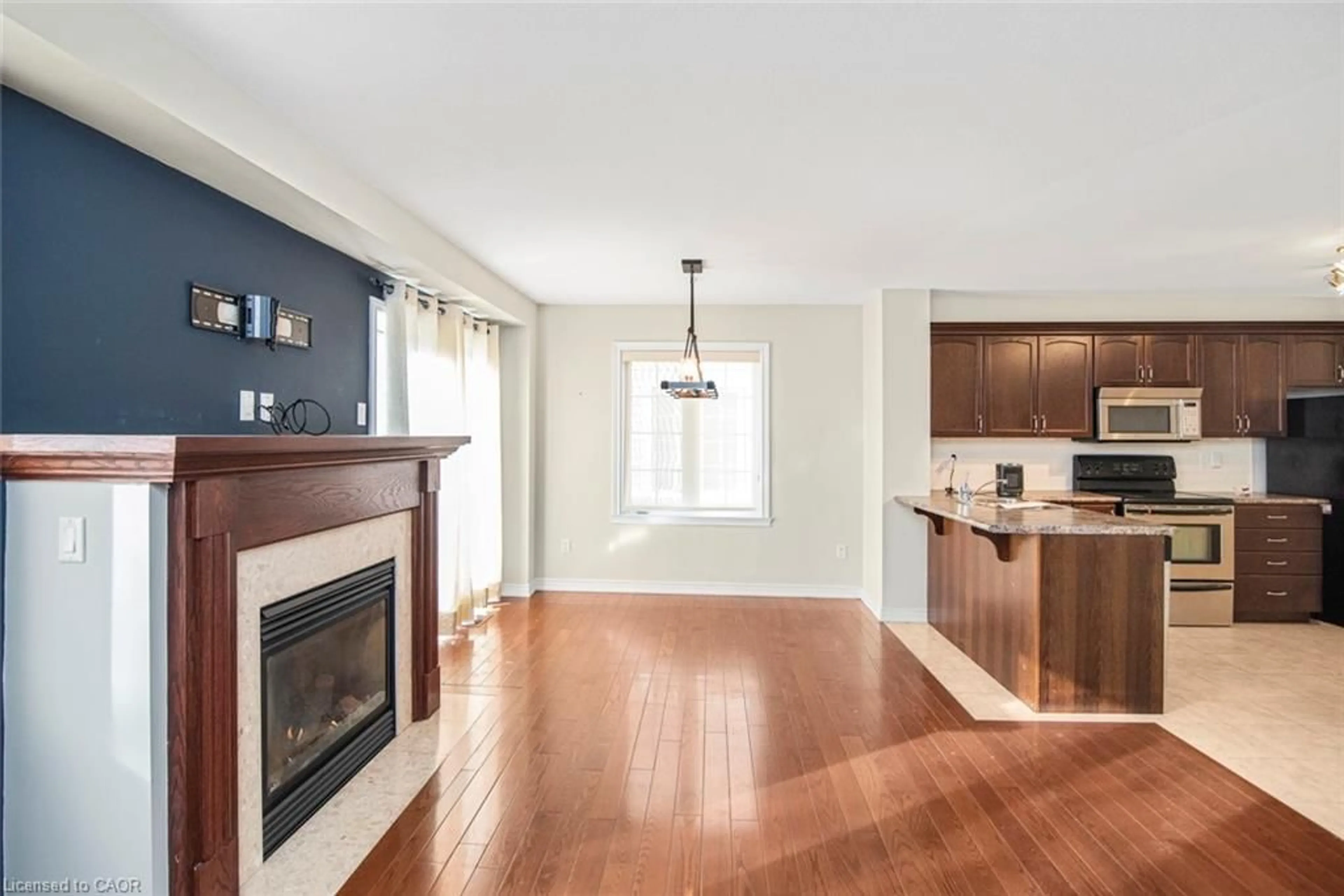 Open concept kitchen, wood/laminate floor for 222 Fall Fair Way #23, Binbrook Ontario L0R 1C0