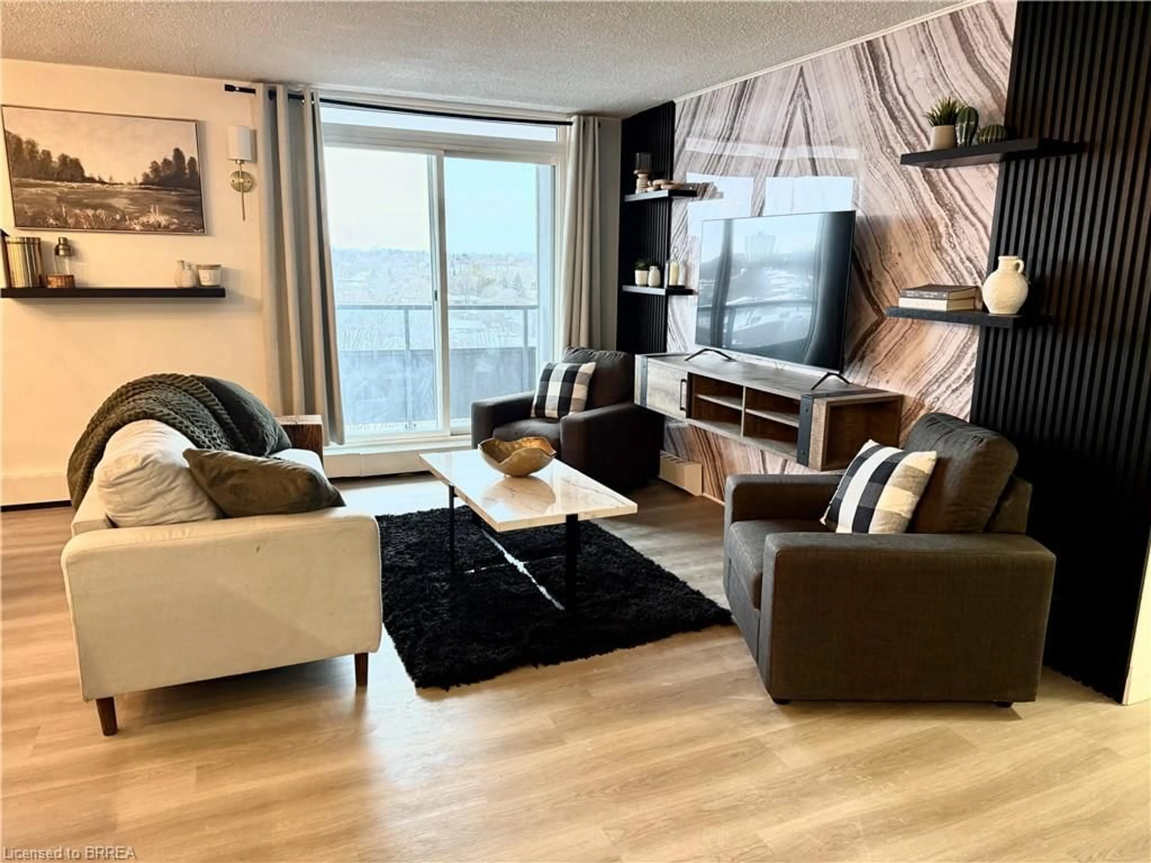 Living room with furniture, wood/laminate floor for 640 West St #908, Brantford Ontario N3R 6M3