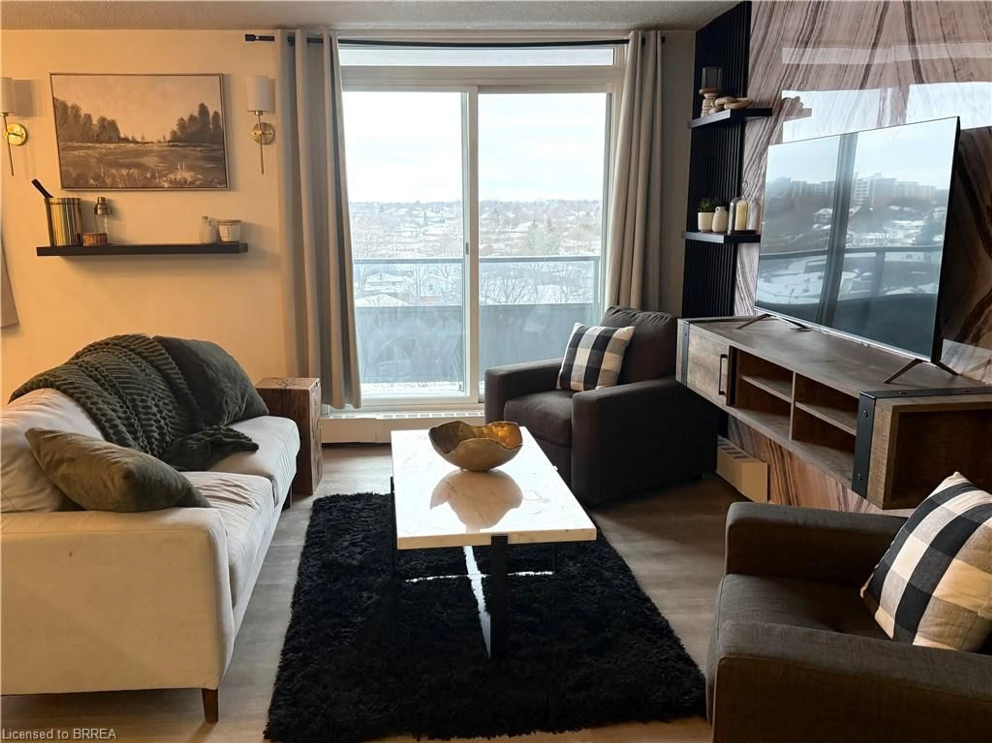 Living room with furniture, wood/laminate floor for 640 West St #908, Brantford Ontario N3R 6M3