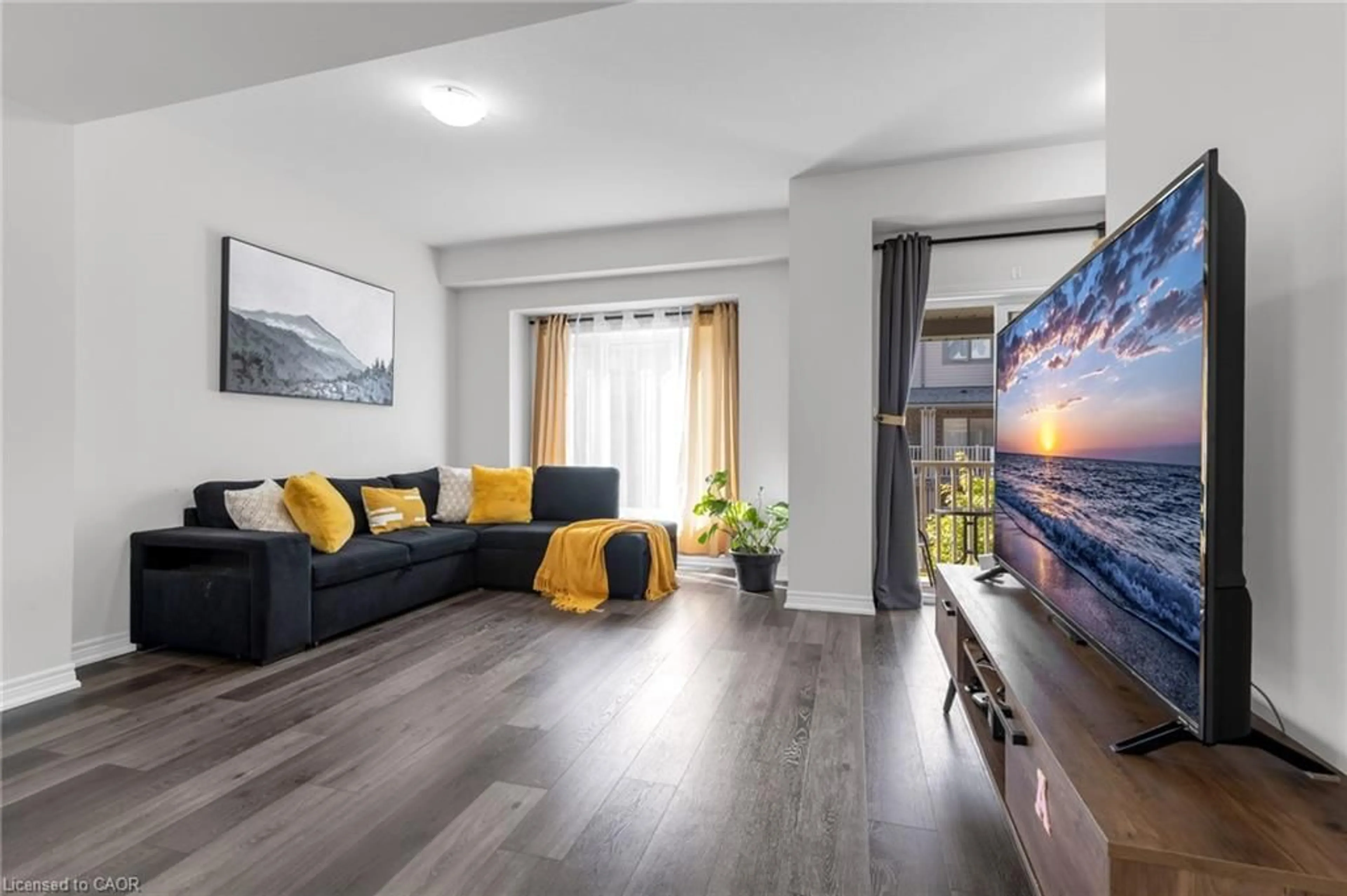 Living room with furniture, wood/laminate floor for 19 Picardy Dr #15, Stoney Creek Ontario L8J 0M7