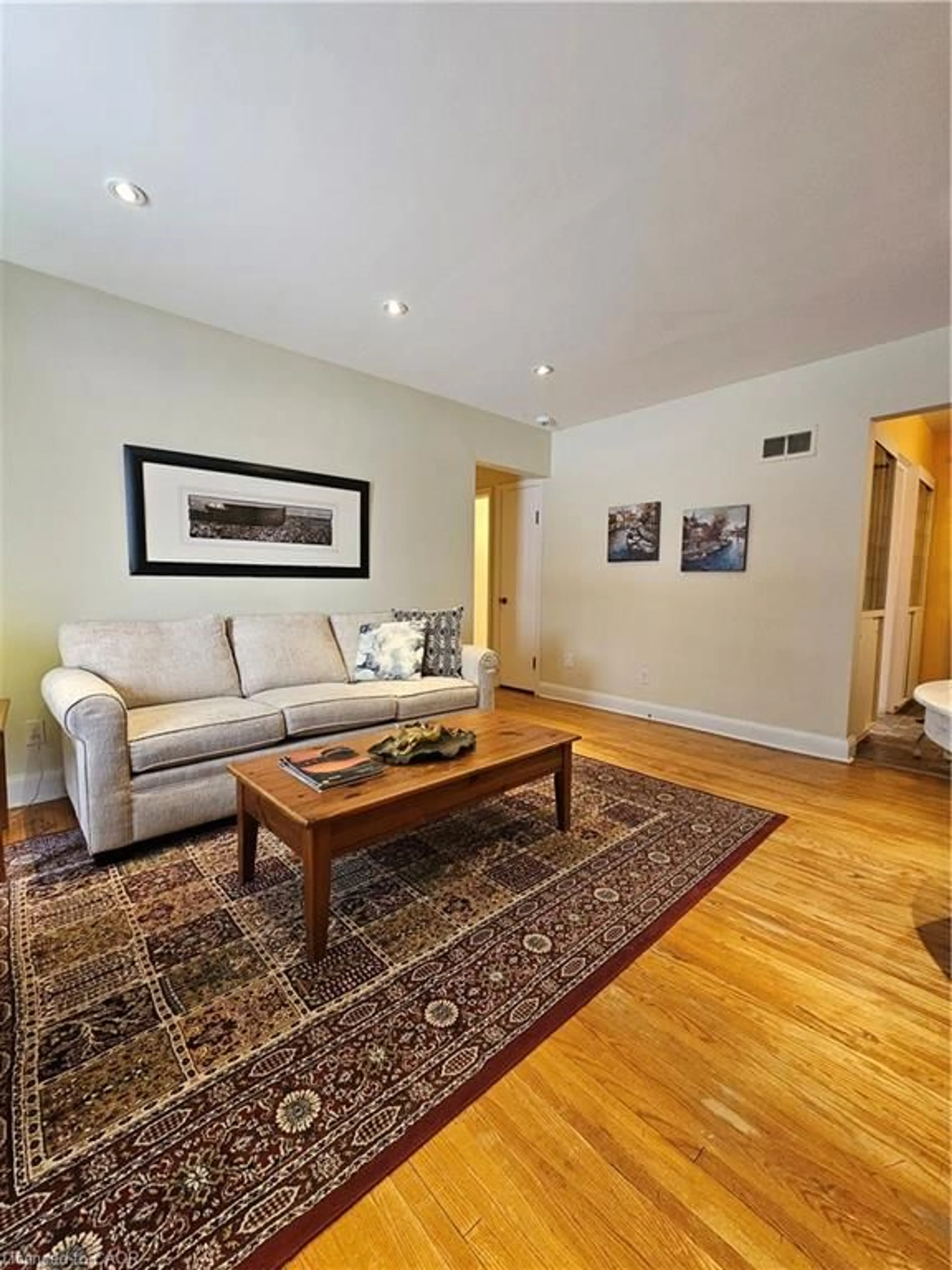 Living room with furniture, wood/laminate floor for 379 St. Leger St, Kitchener Ontario N2H 4M8