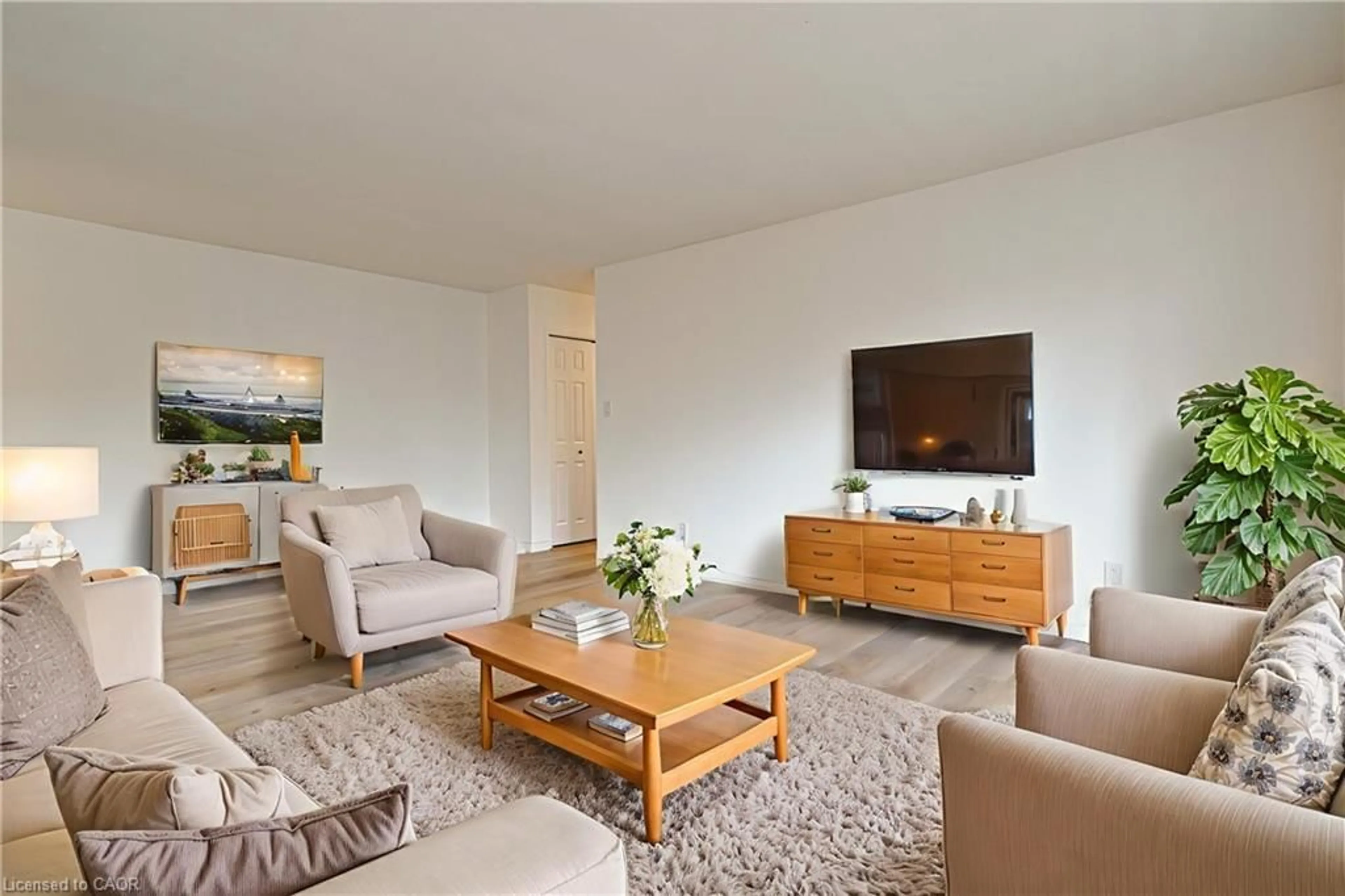 Living room with furniture, wood/laminate floor for 283 Fairway Rd #405, Kitchener Ontario N2A 2P1