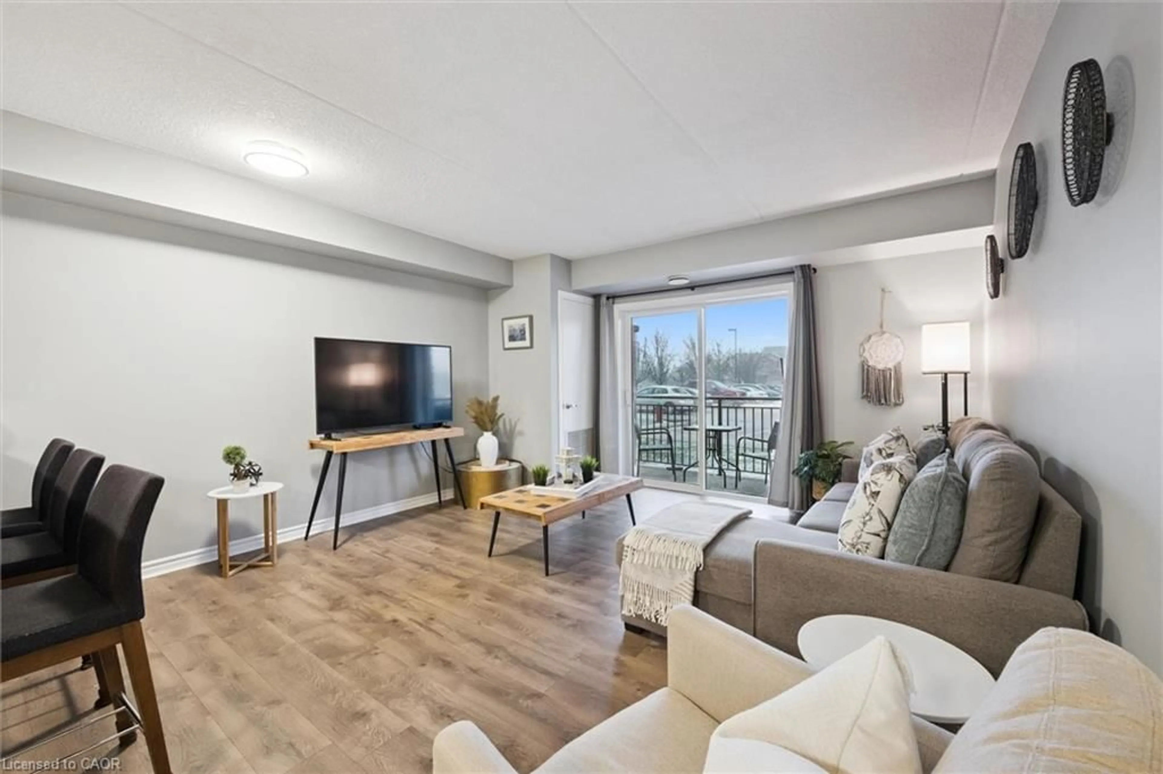 Living room with furniture, wood/laminate floor for 19 Waterford Dr #109, Guelph Ontario N1L 0G8