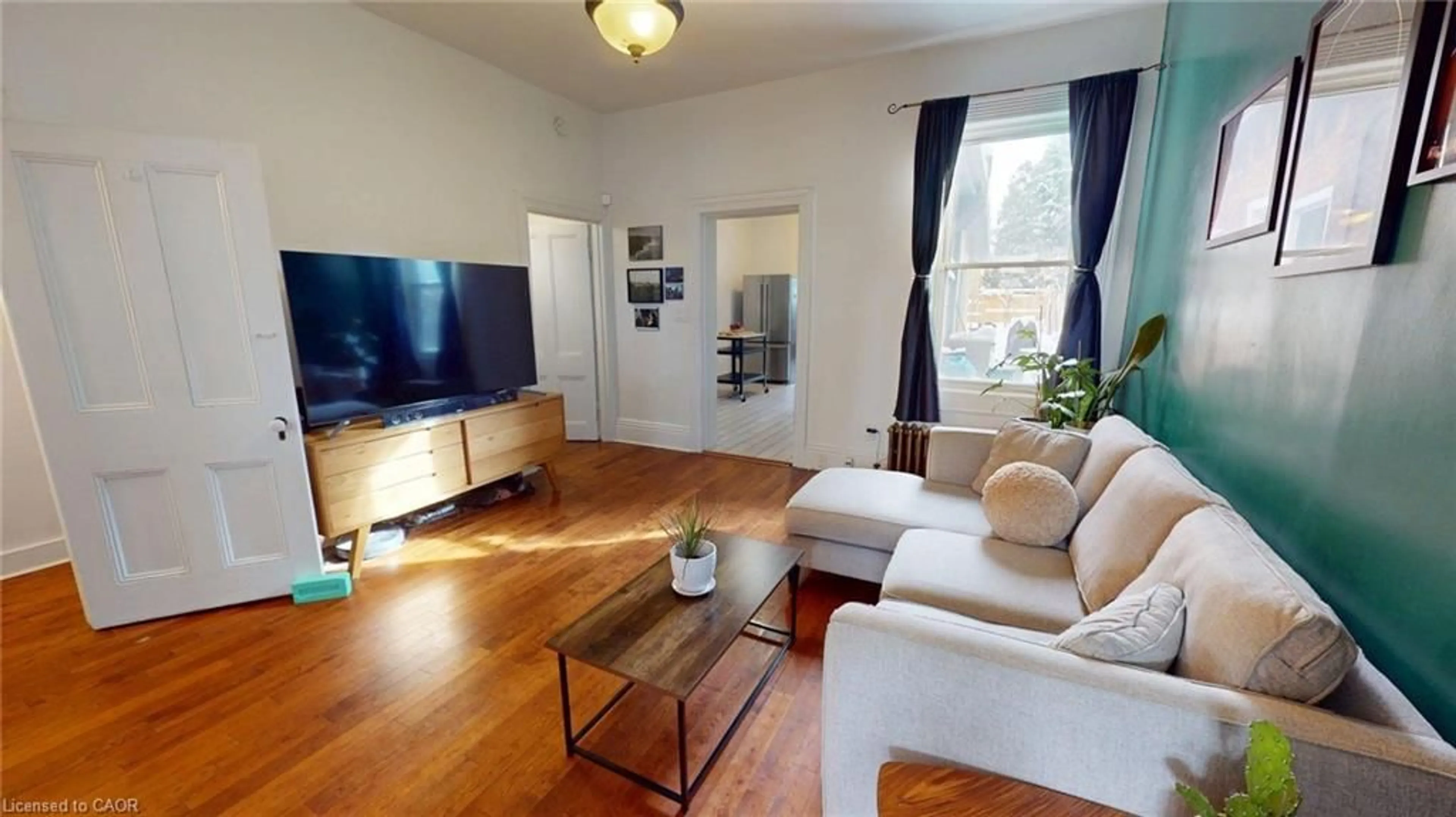 Living room with furniture, wood/laminate floor for 132 Ferguson Ave, Hamilton Ontario L8R 1L7