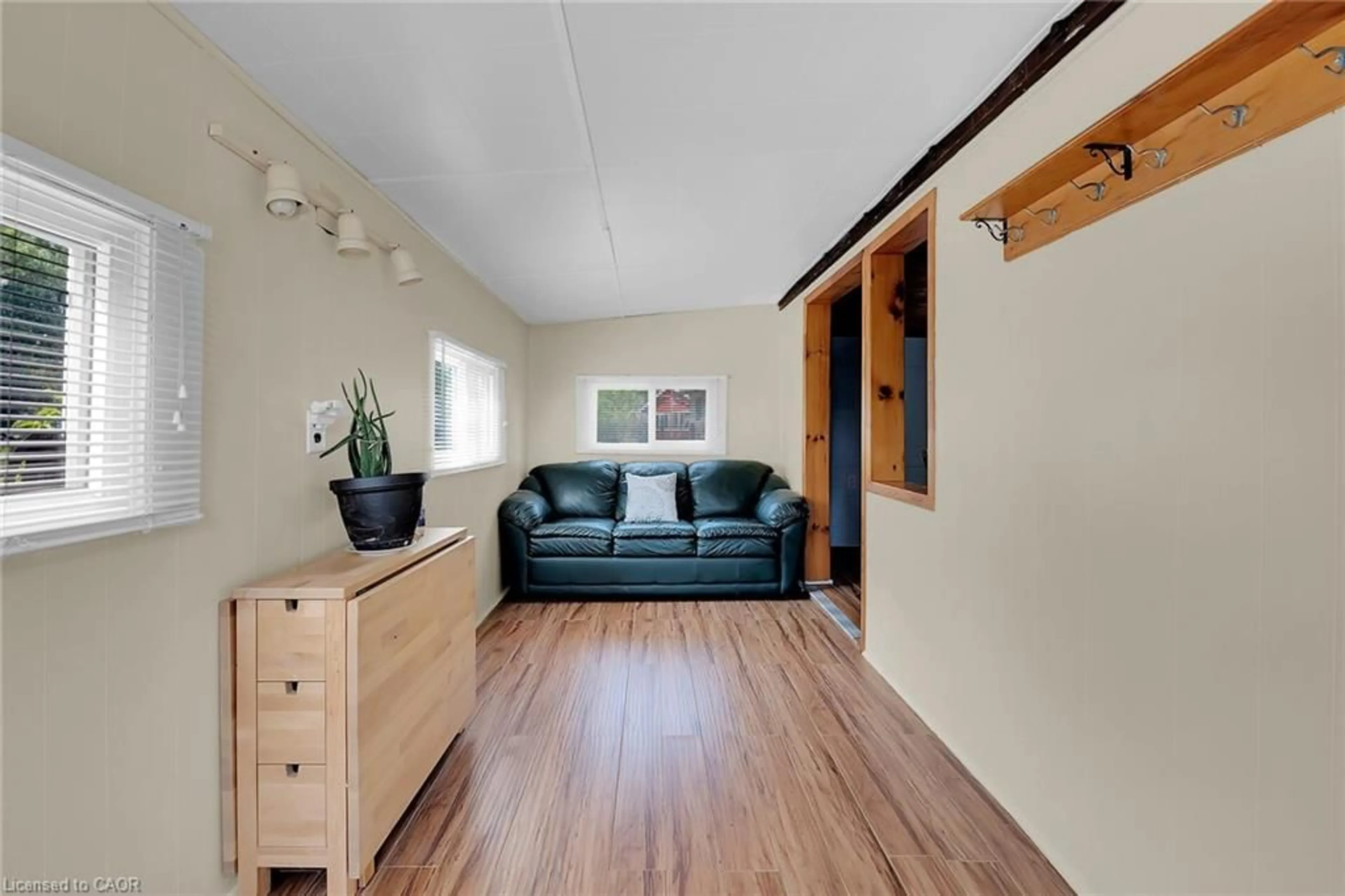 Living room with furniture, wood/laminate floor for 17 Maple Lane, Rainham Ontario N0A 1P0