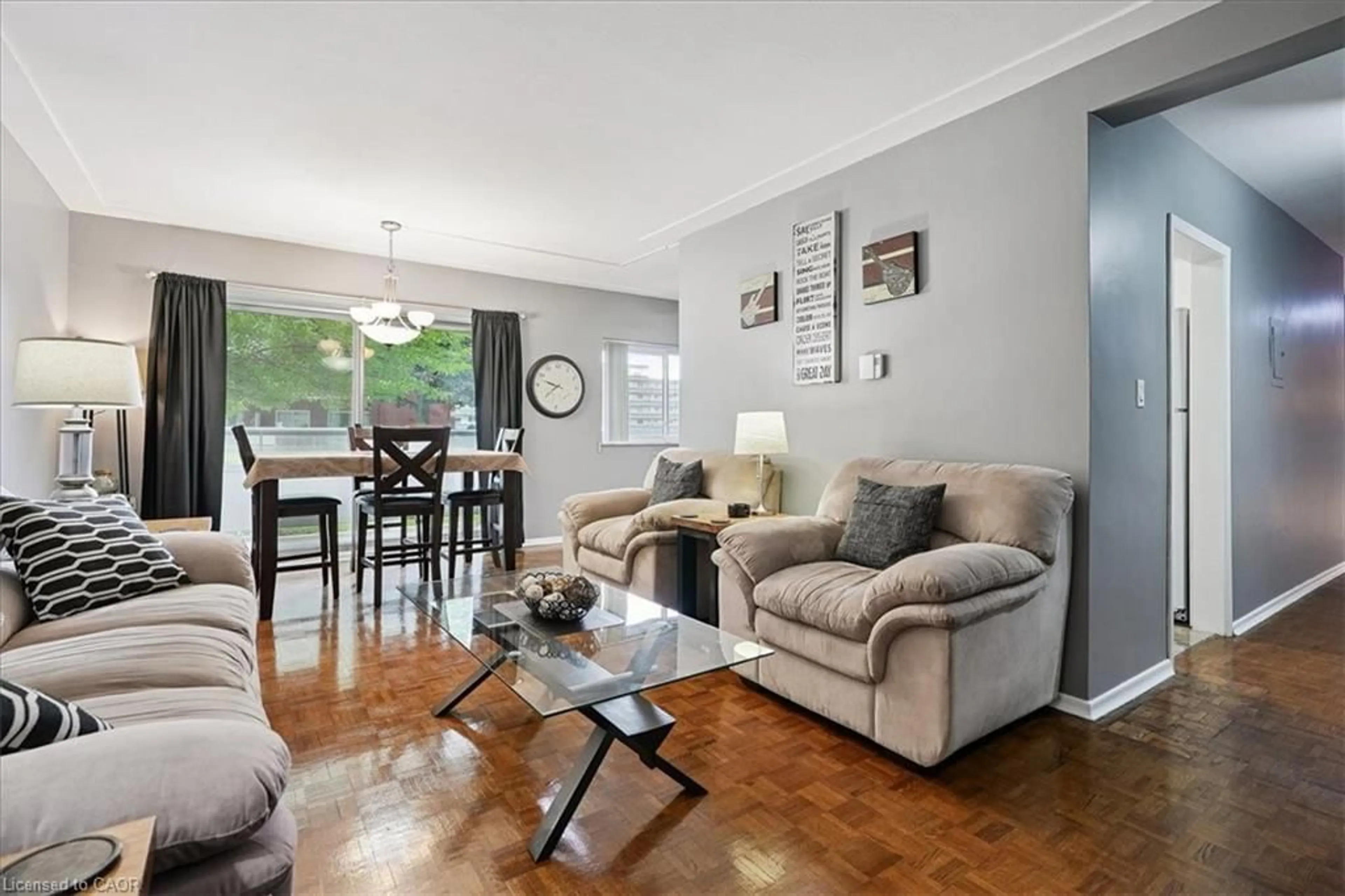 Living room with furniture, wood/laminate floor for 11 Woodman Dr #102, Hamilton Ontario L8K 4E3