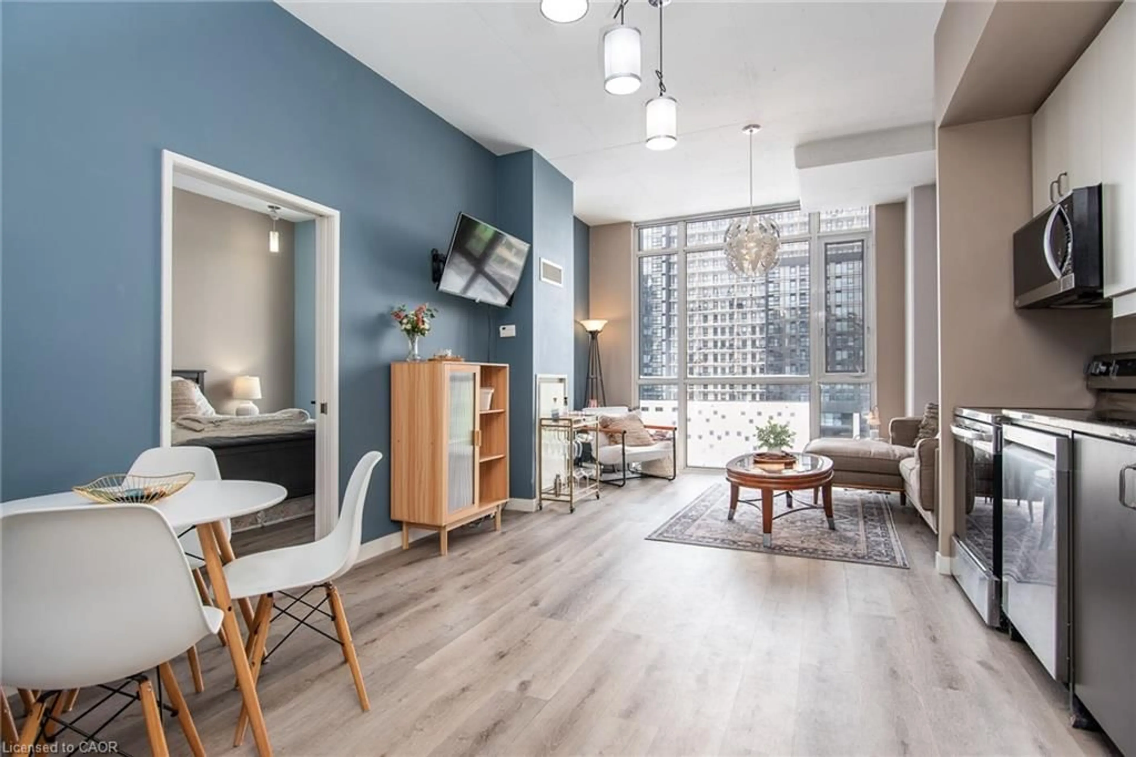 Living room with furniture, wood/laminate floor for 191 King St #702, Waterloo Ontario N2J 1R1