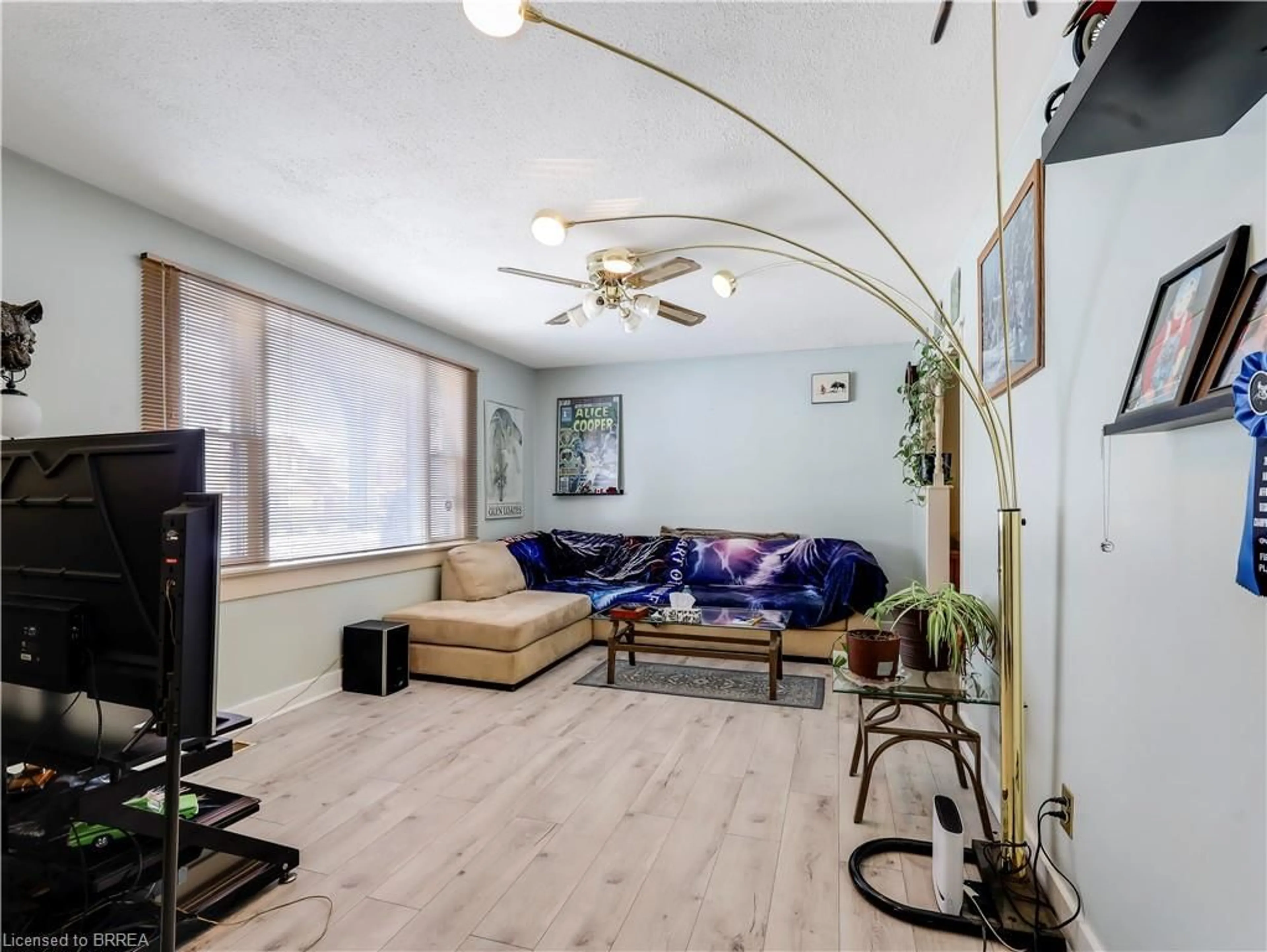 Living room with furniture, wood/laminate floor for 389 Grey St, Brantford Ontario N3S 4X6