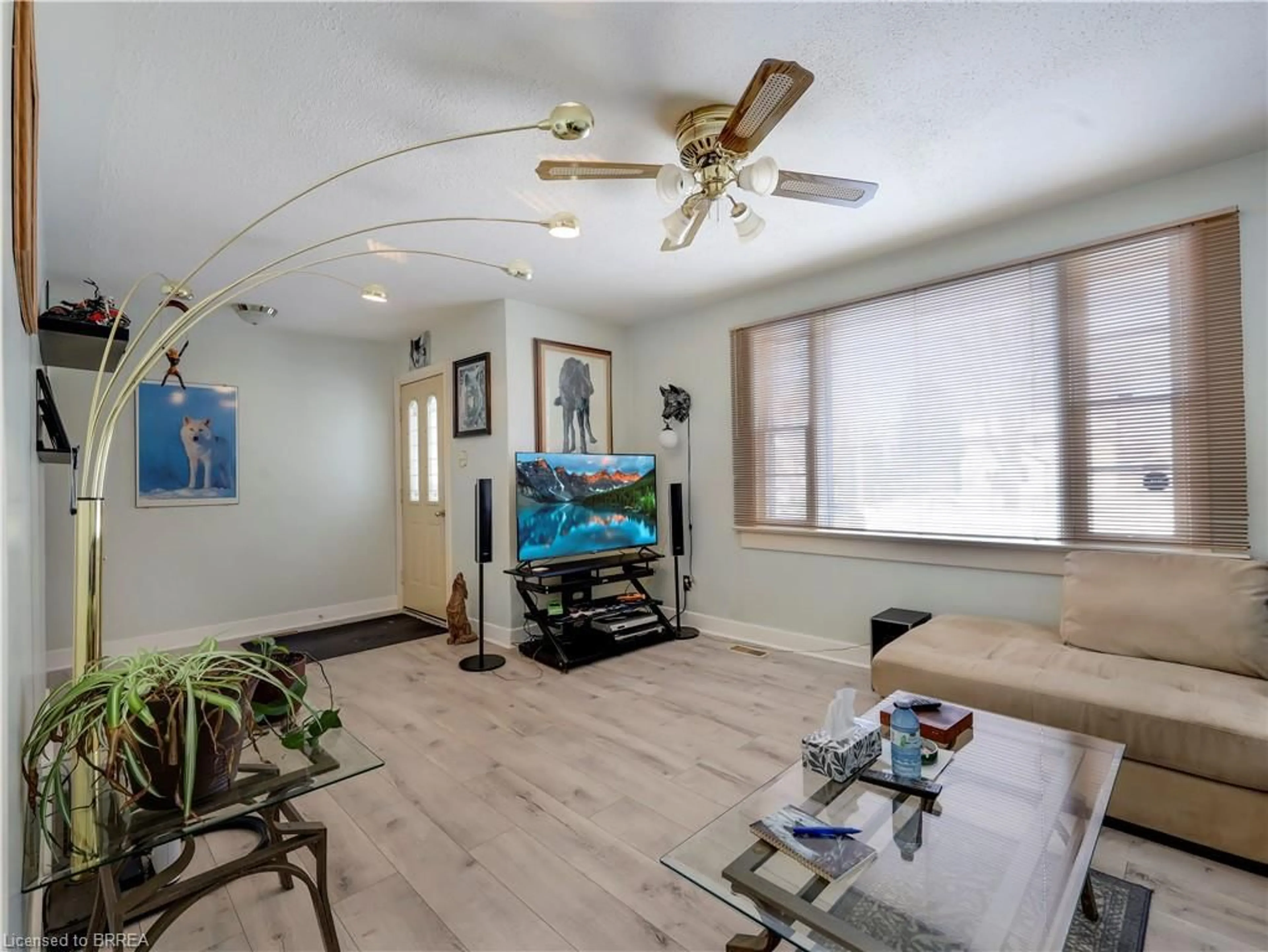 Living room with furniture, wood/laminate floor for 389 Grey St, Brantford Ontario N3S 4X6