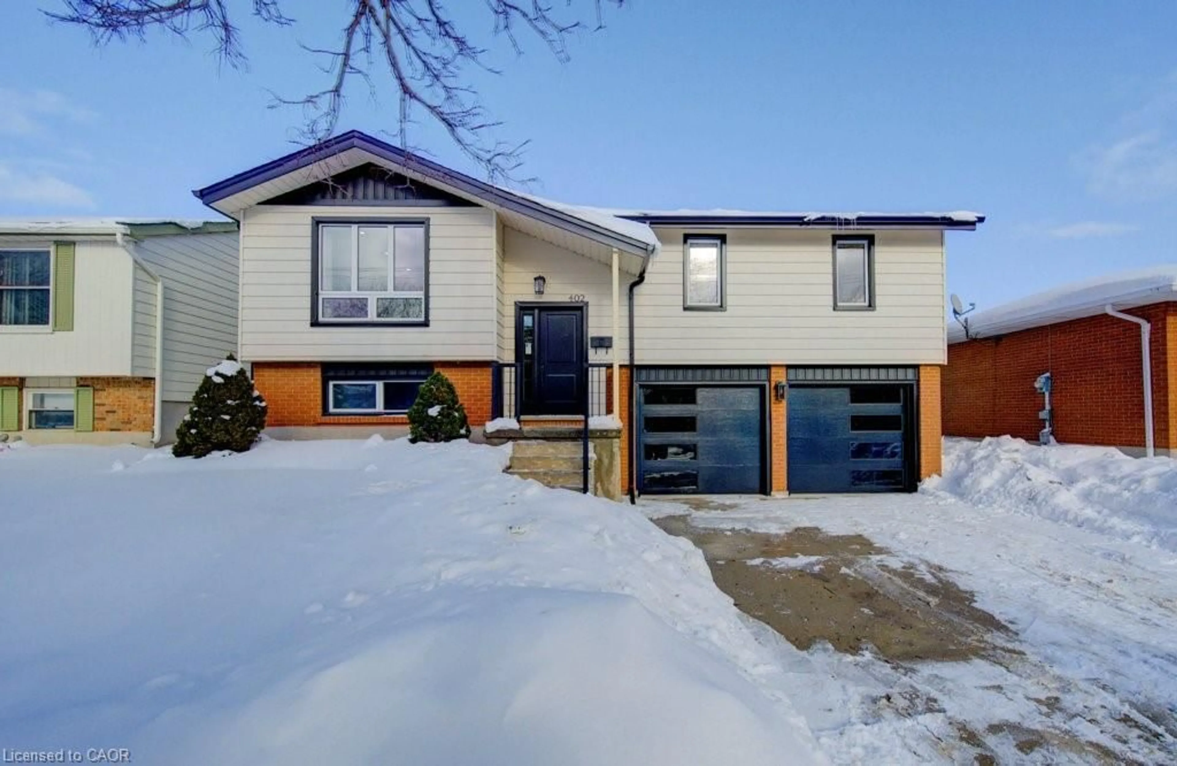 Home with vinyl exterior material, street for 402 Heritage Dr, Kitchener Ontario N2B 3M9