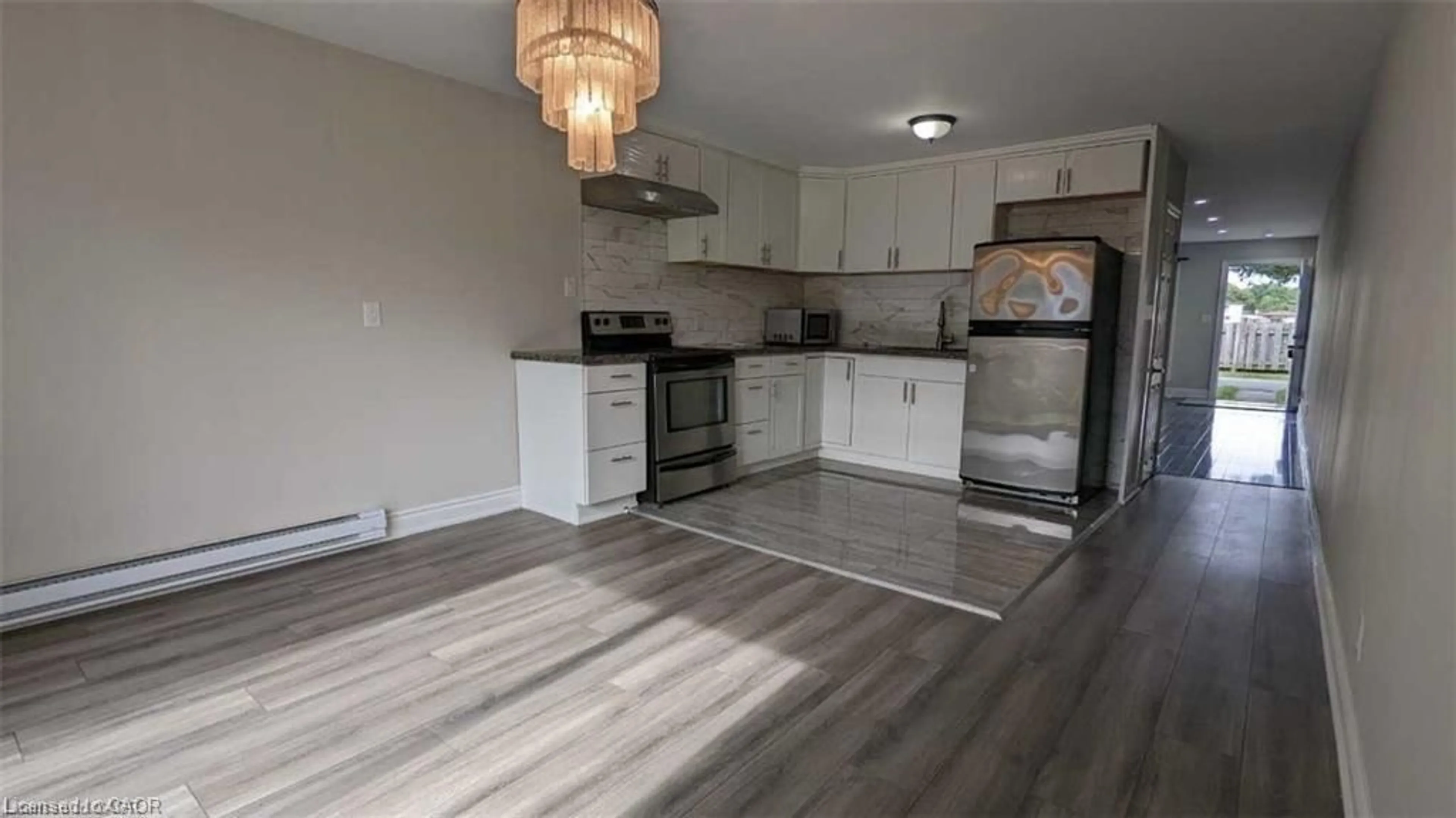 Open concept kitchen, wood/laminate floor for 8646 Willoughby Dr #18, Niagara Falls Ontario L2G 6X7