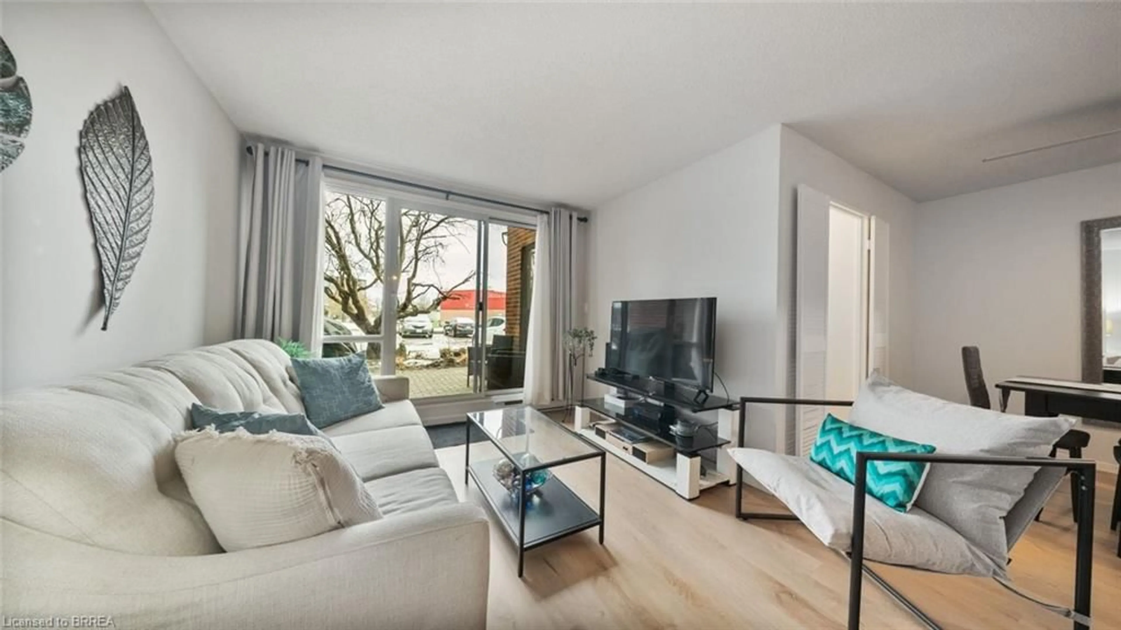 Living room with furniture, wood/laminate floor for 36 Hayhurst Rd #136, Brantford Ontario N3R 6Y9