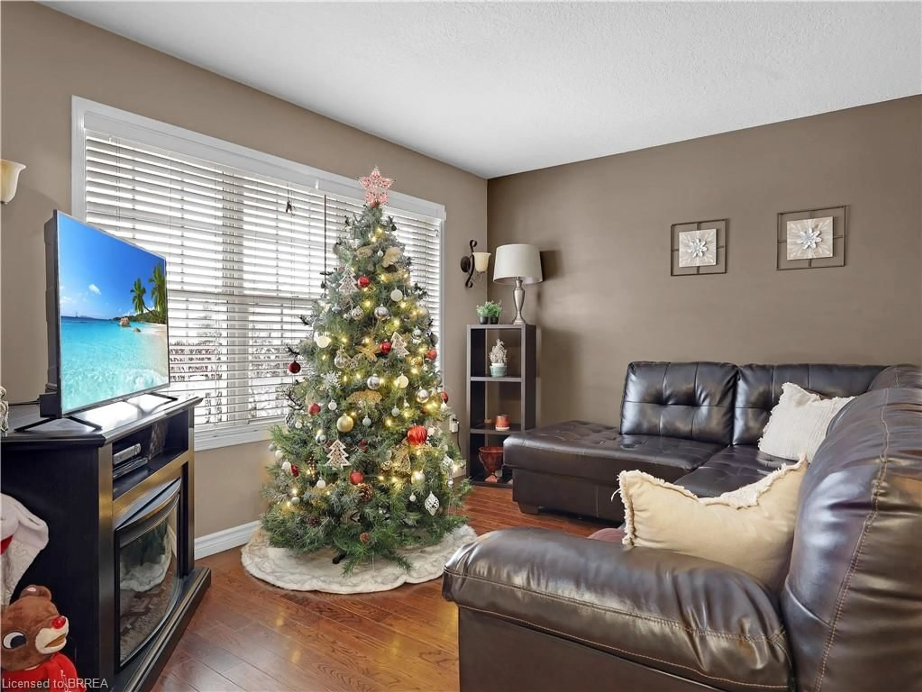 Living room with furniture, wood/laminate floor for 66 Gaydon Way, Brantford Ontario N3T 6M9
