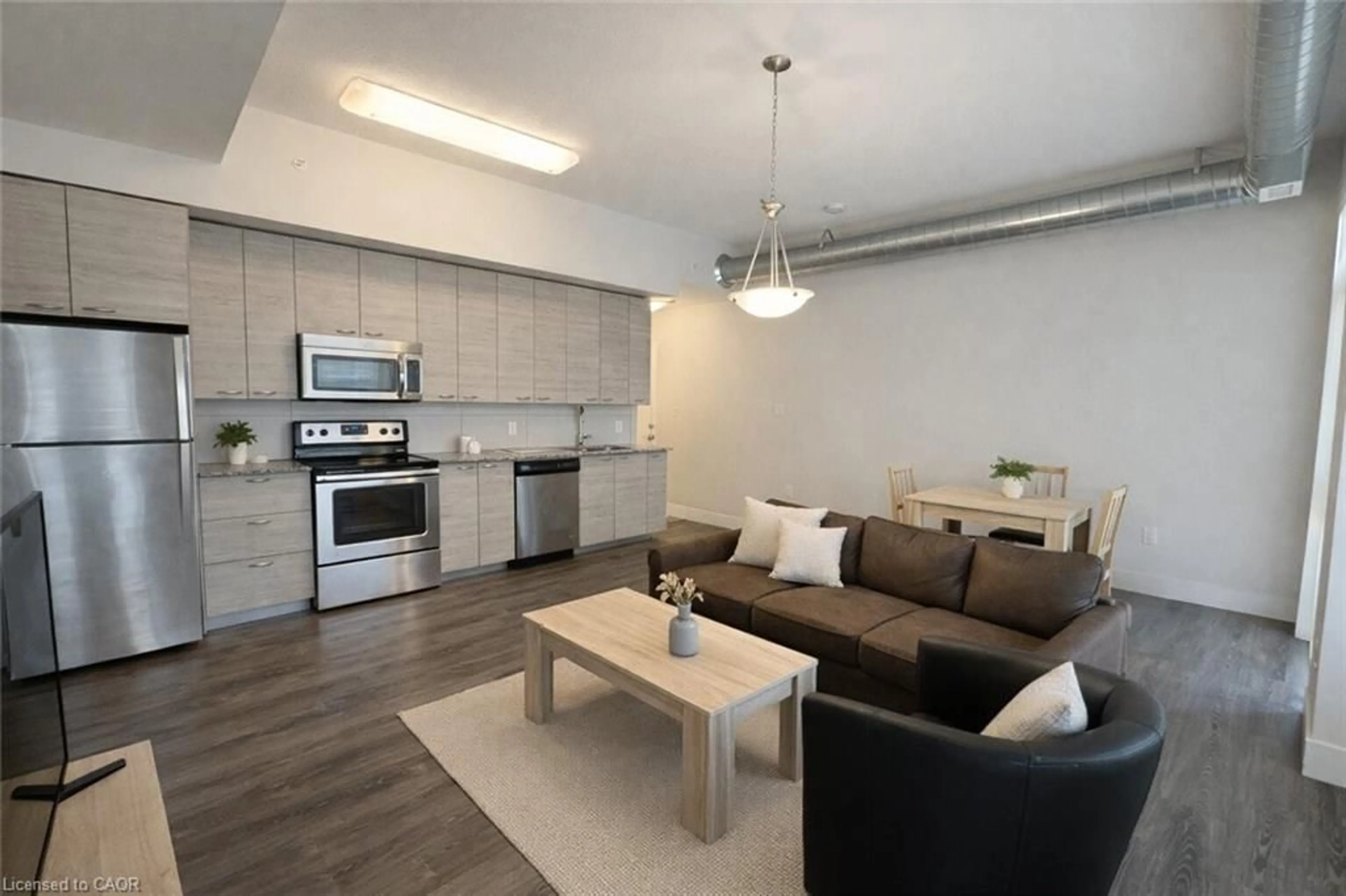 Open concept kitchen, wood/laminate floor for 253 Albert St #410, Waterloo Ontario N2L 0G3