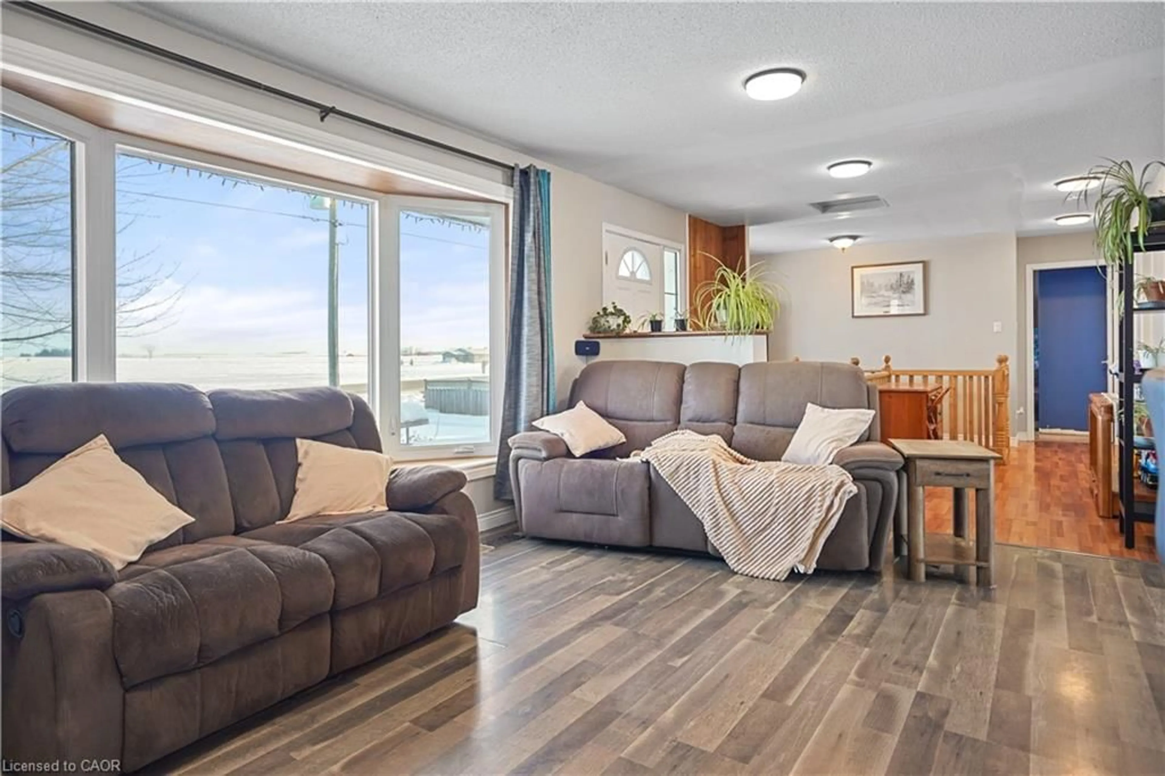 Living room with furniture, wood/laminate floor for 4021 Perth Line 56, Milverton Ontario N0K 1M0