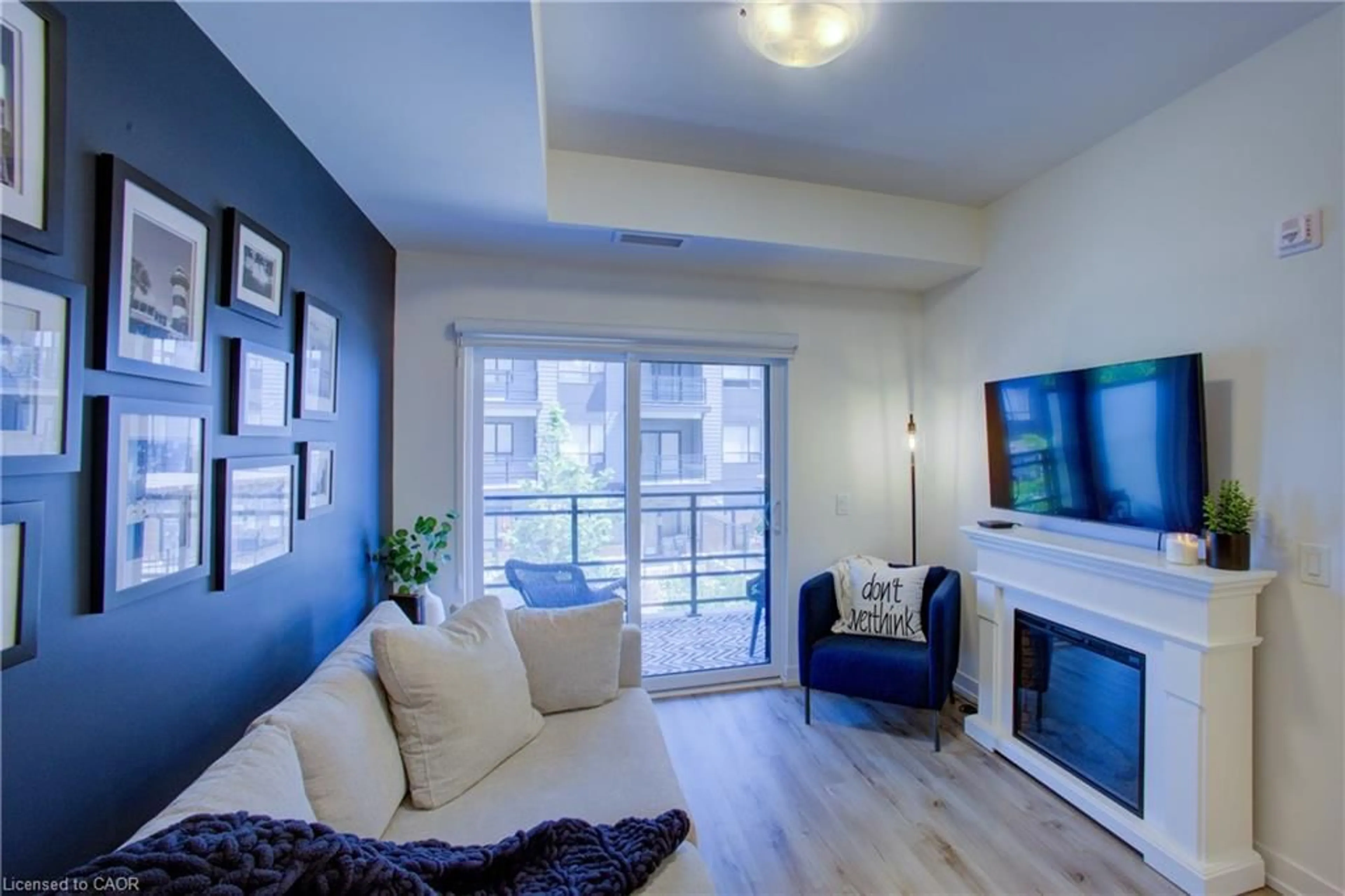 Living room with furniture, wood/laminate floor for 243 Northfield Dr #208, Waterloo Ontario N2K 0H2