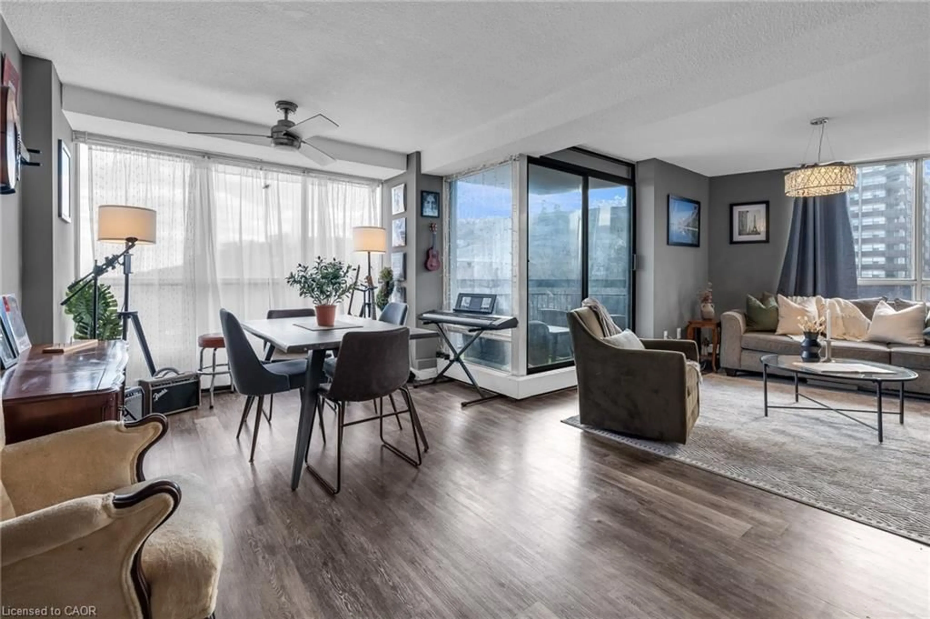 Living room with furniture, wood/laminate floor for 150 Charlton Ave #1406, Hamilton Ontario L8N 3X3