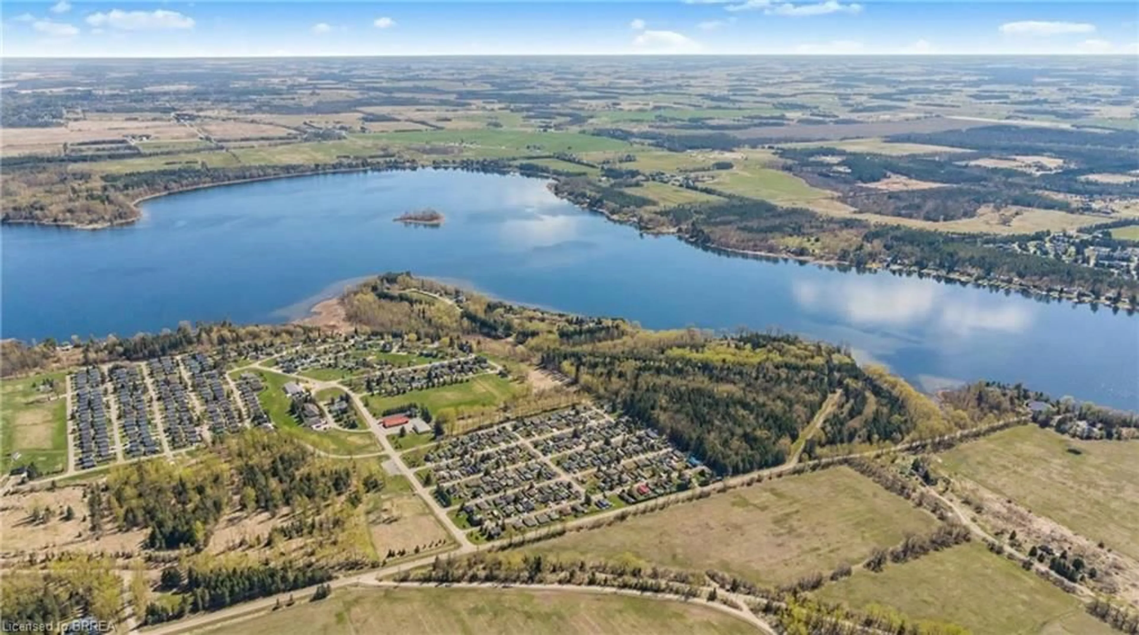 A pic from outside/outdoor area/front of a property/back of a property/a pic from drone, water/lake/river/ocean view for 428 Pine Pass, Wellington Ontario N1M 2W5