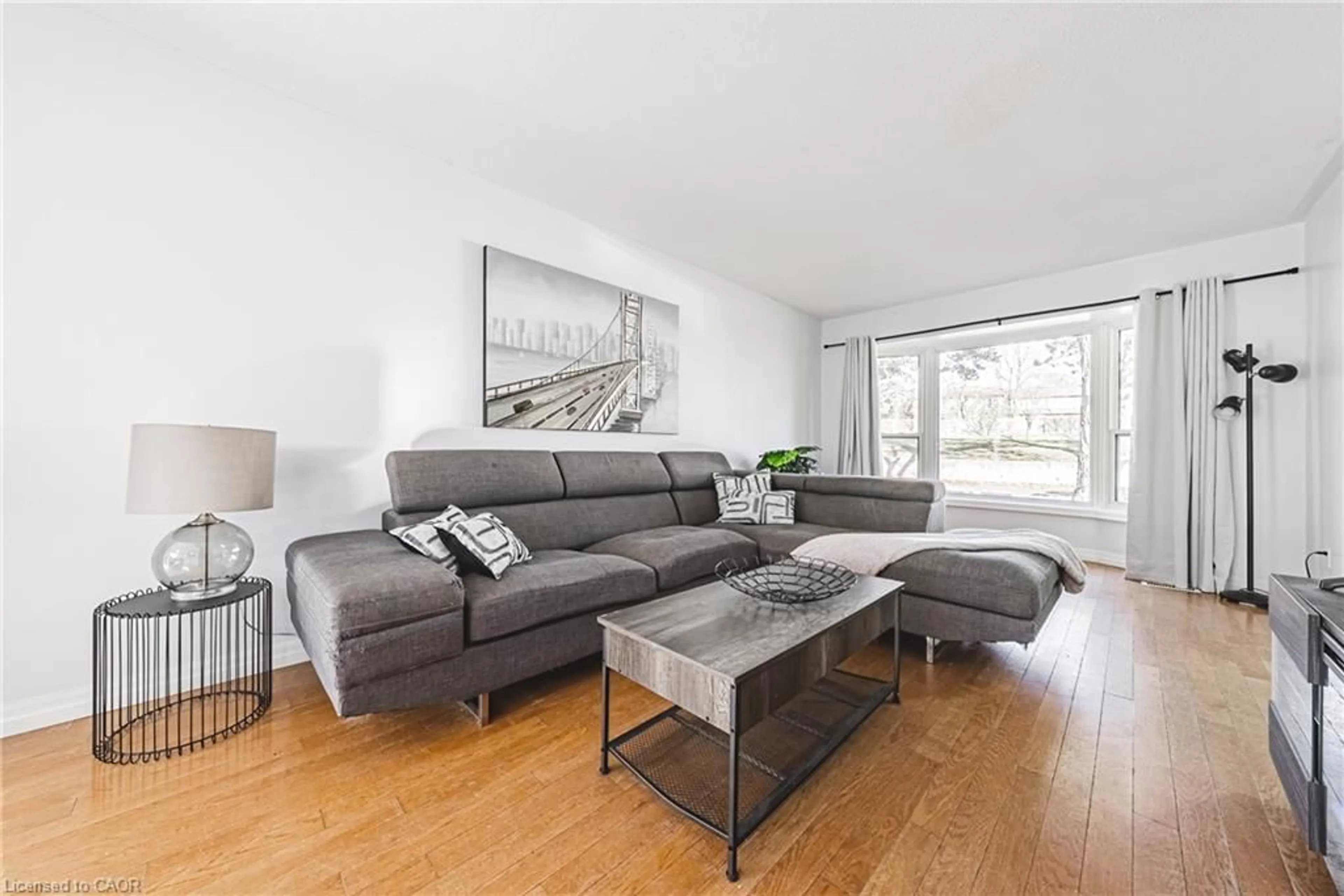 Living room with furniture, wood/laminate floor for 2220 Upper Middle Rd #4, Burlington Ontario L7P 2Z9