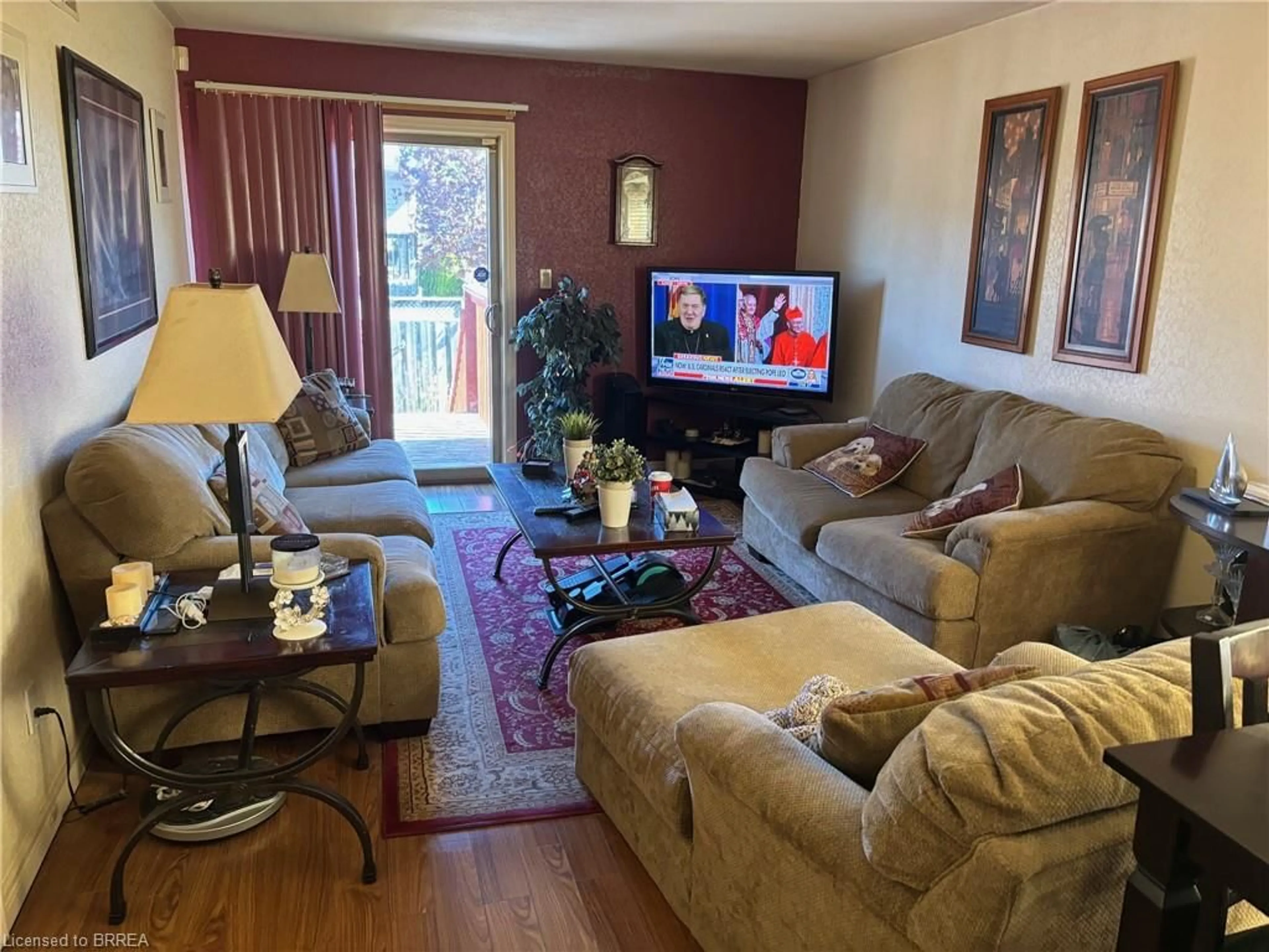 Living room with furniture, wood/laminate floor for 594 Grey St, Brantford Ontario N3S 4Y1