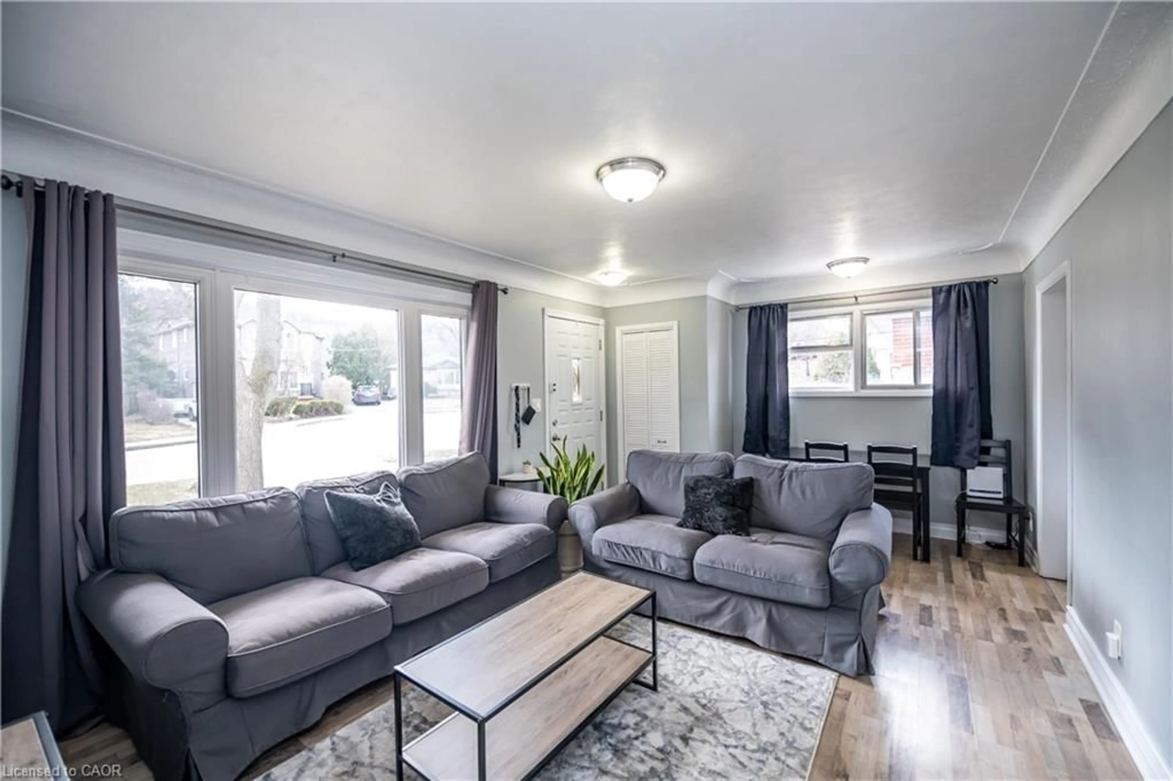 Living room with furniture, wood/laminate floor for 62 Harold Crt, Hamilton Ontario L8S 2R9