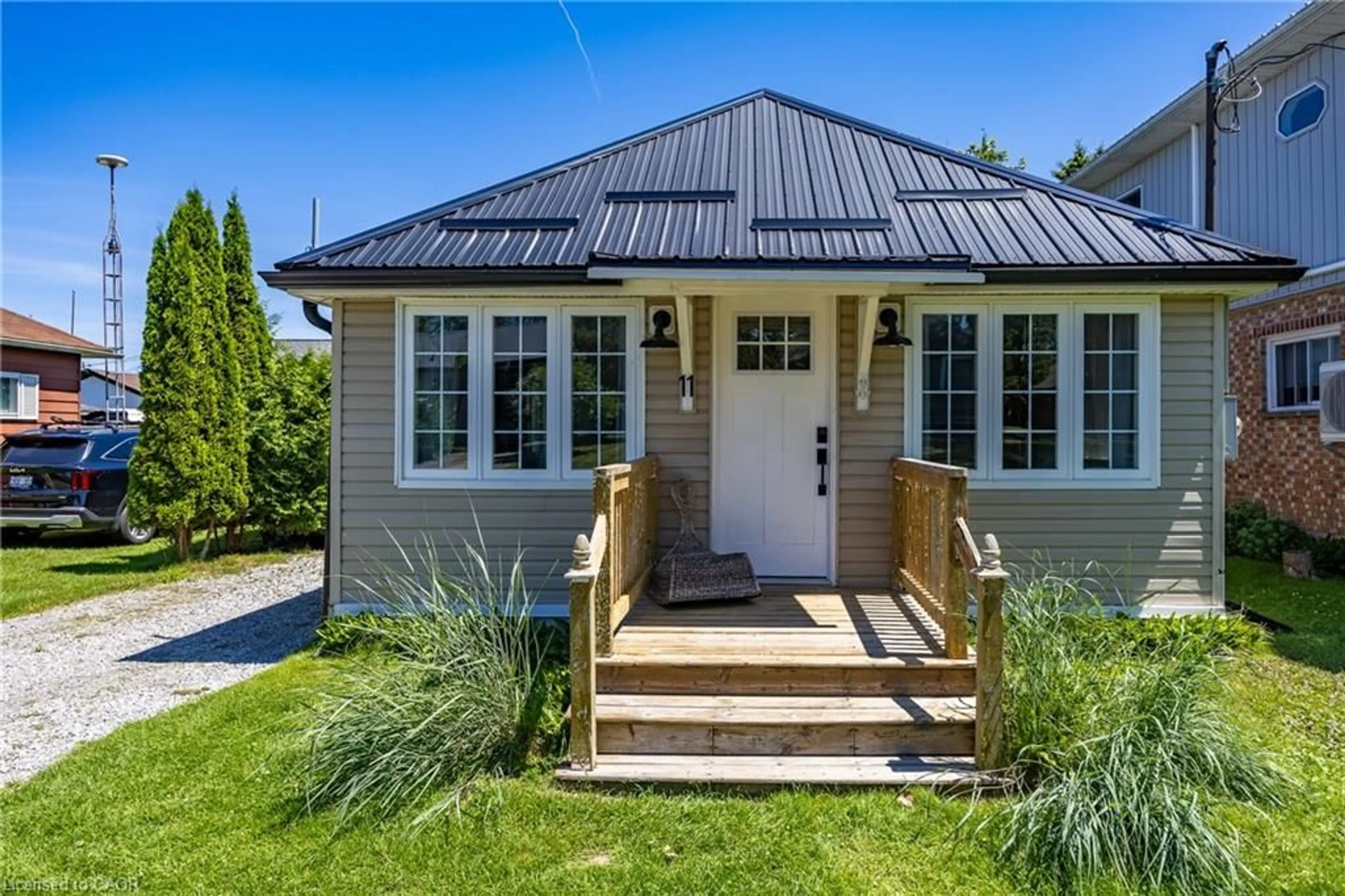 Home with vinyl exterior material, street for 11 Bass Lane, Long Point Ontario N0E 1M0