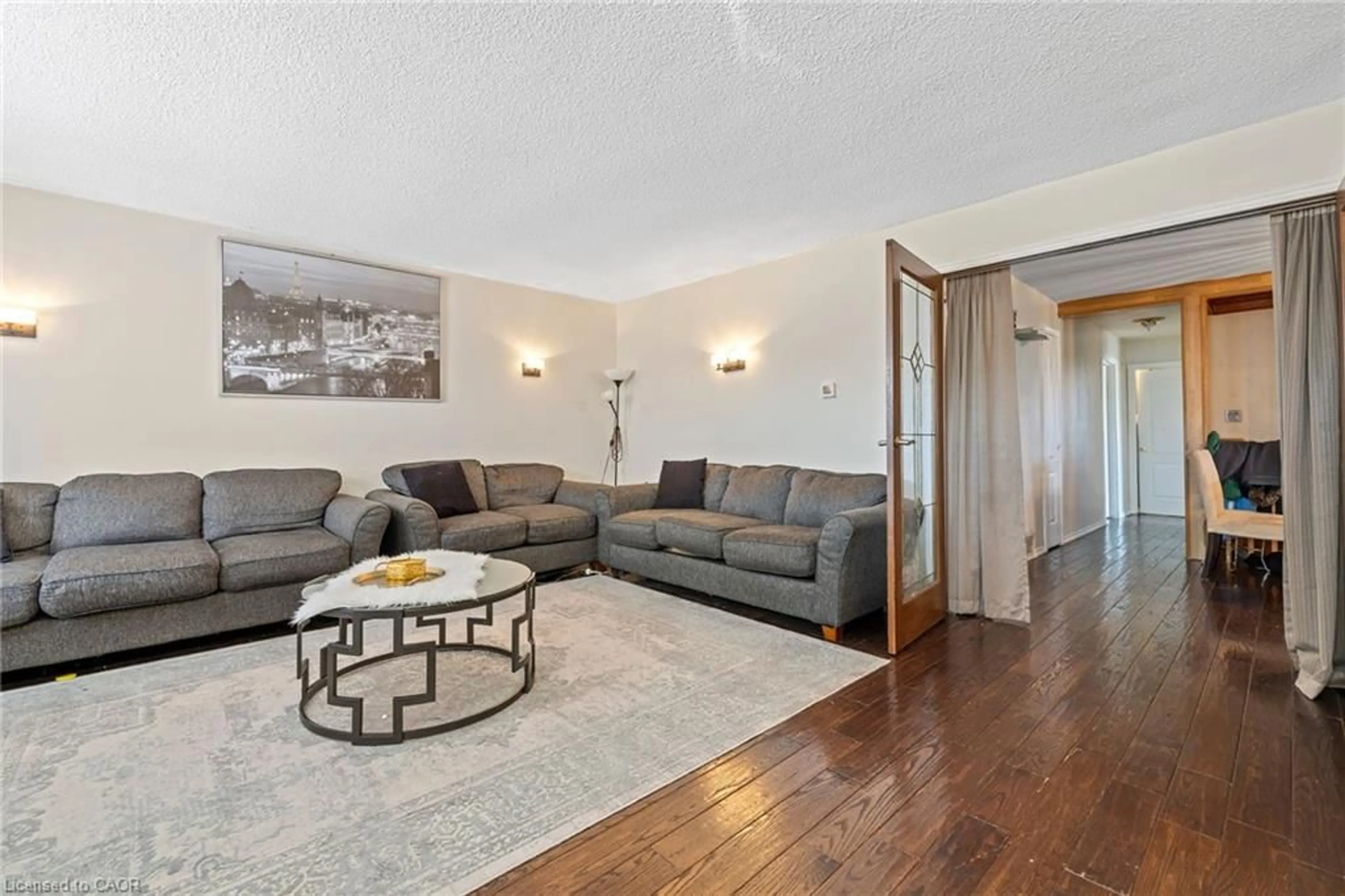 Living room with furniture, wood/laminate floor for 490 Queen Victoria Dr, Hamilton Ontario L8W 1G9