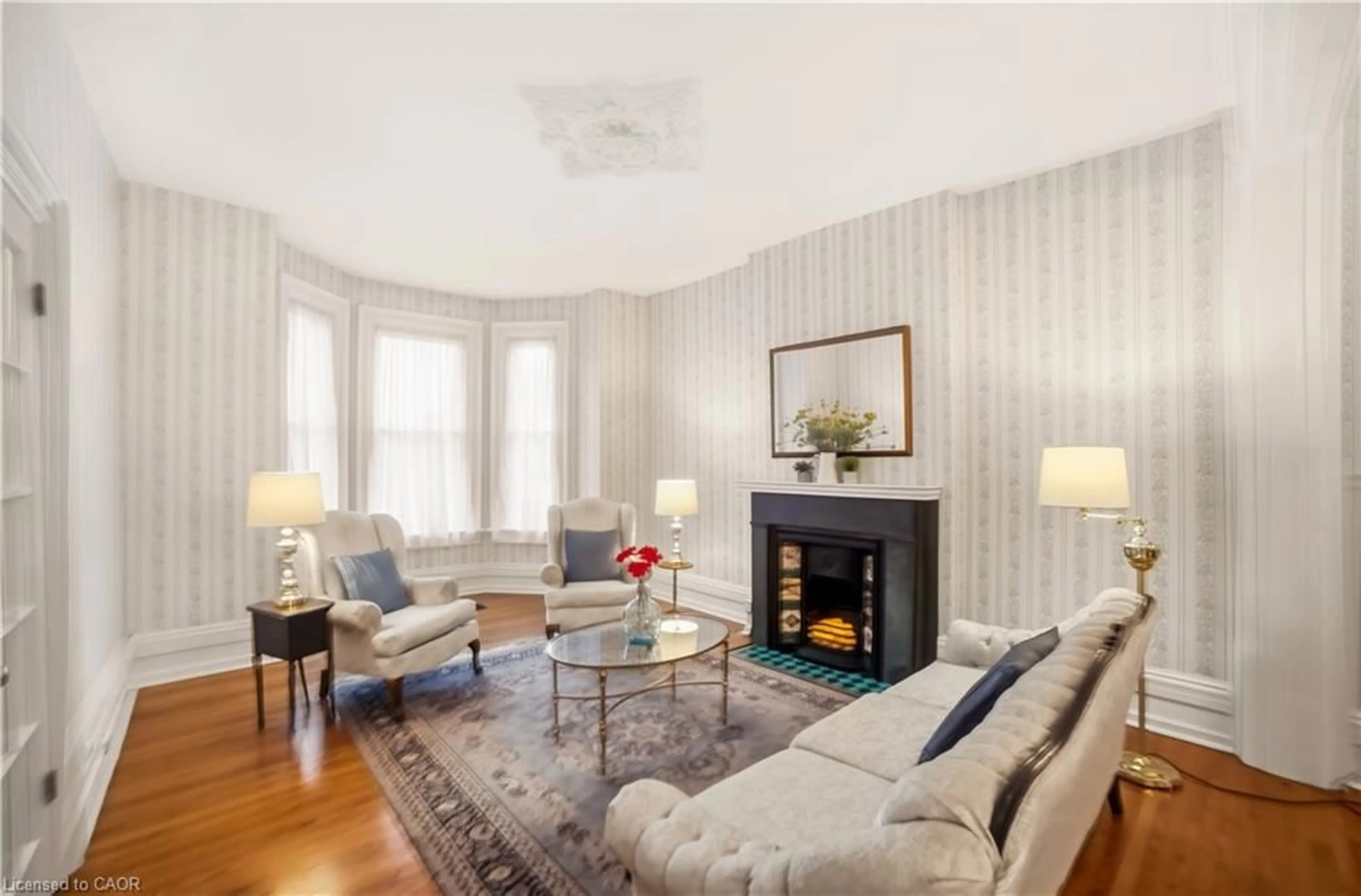 Living room with furniture, wood/laminate floor for 306 John St, Hamilton Ontario L8L 4P9